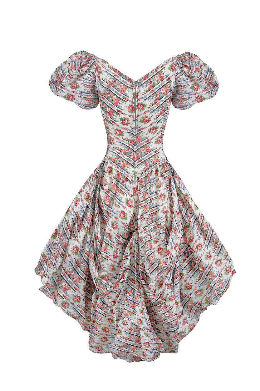 This is one of the most interesting and unusual antique dresses we have ever had at Circa and of extraordinary construction. It is modelled on an earlier 18th century Polynesian style dress and is made from a very fine cotton in a sweet floral