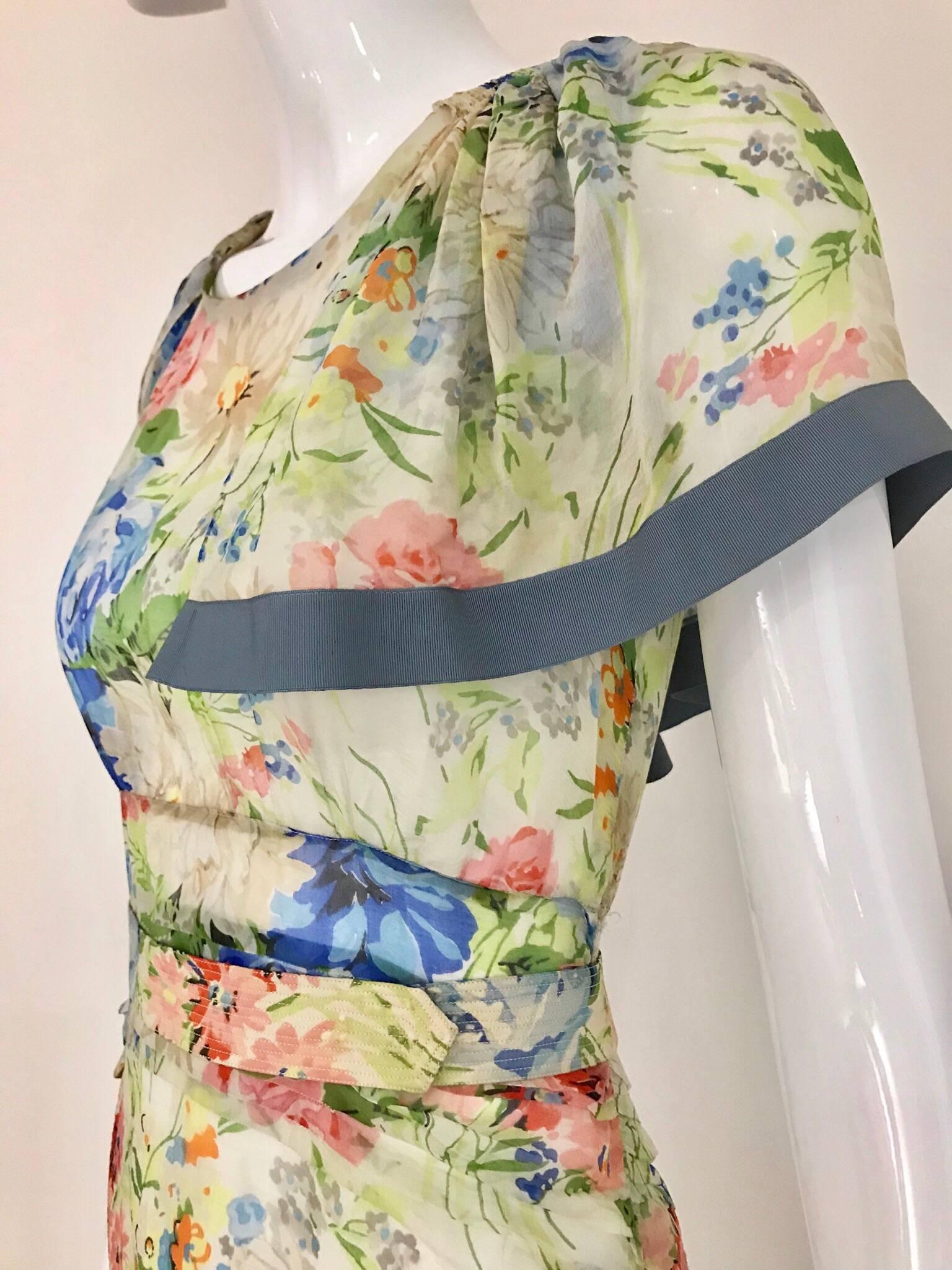 1930s White, green, blue , pink and orange floral print silk chiffon dress with silk belt.
Bust: 34
