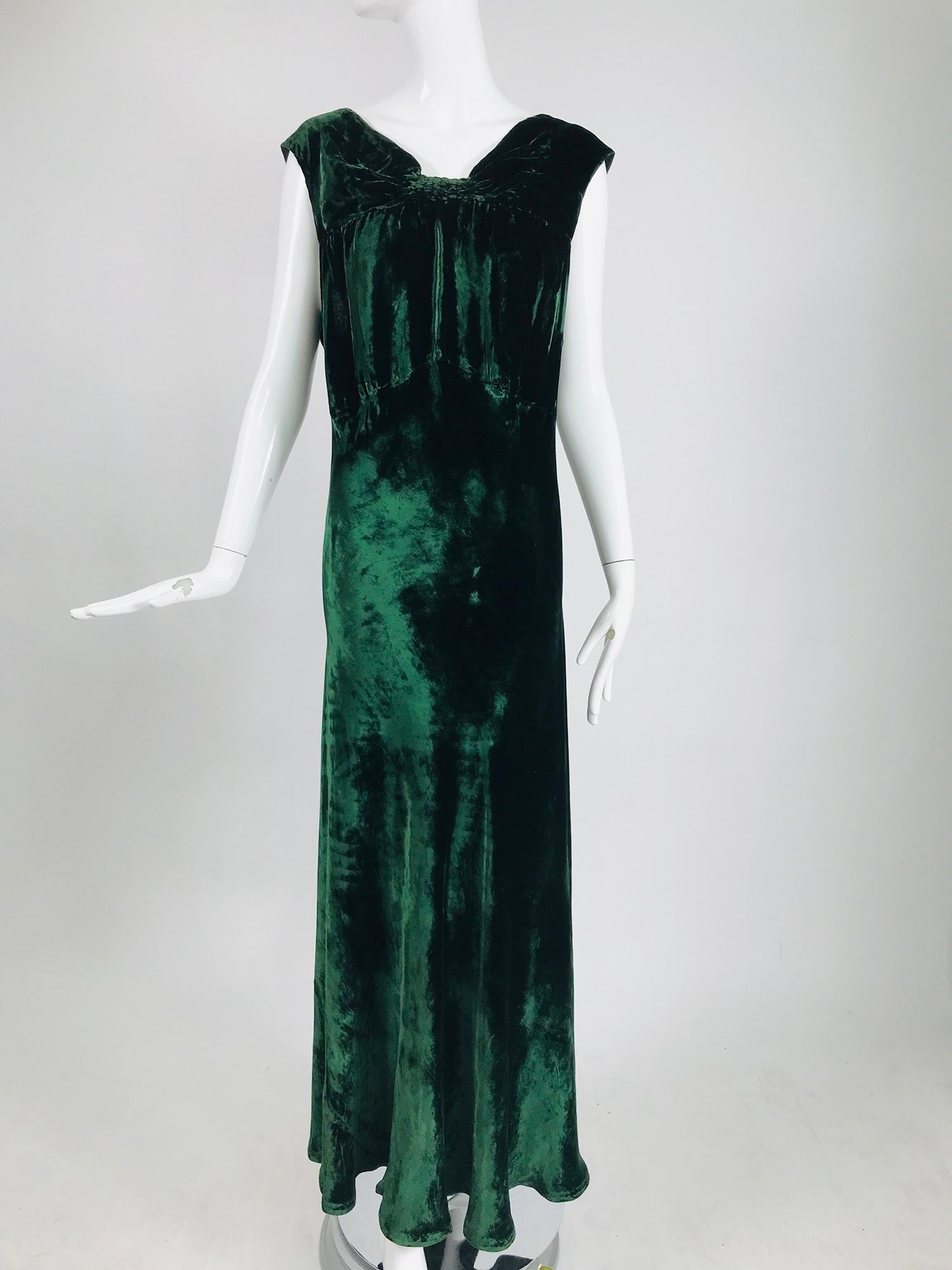 1930s forest green velvet bias cut dress and matching jacket. Beautiful velvet of silk and rayon. The dress has wide shoulder straps and an empire bodice with a long bias cut skirt. The center neck front is shirred, the bodice below is gathered to
