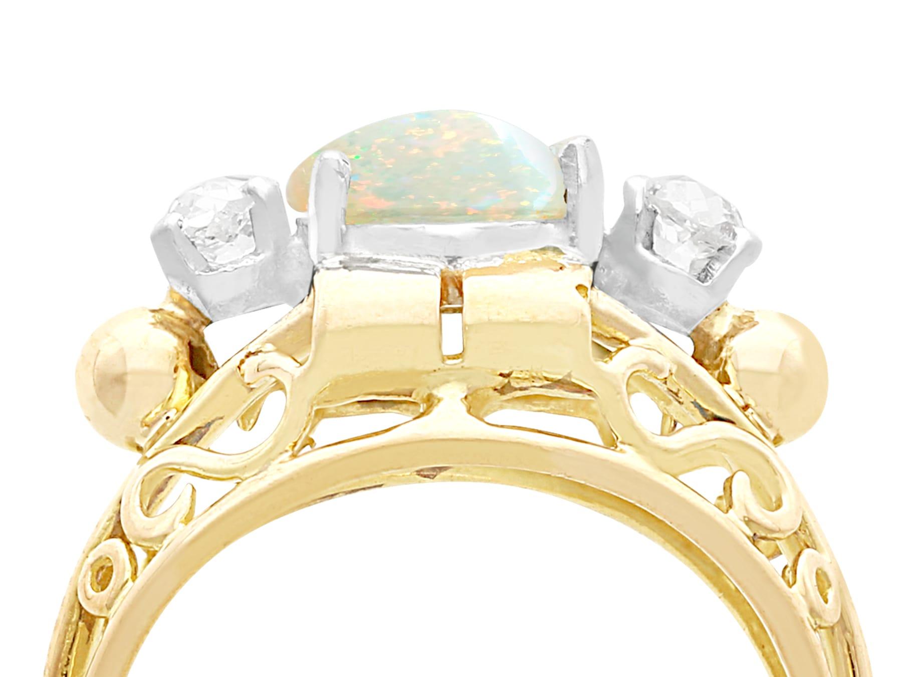 An impressive antique 1.82 carat white opal and 0.35 carat diamond, 18 karat yellow gold and platinum set cocktail ring; part of our diverse antique jewelry collections.

This fine and impressive antique cabochon cut opal and diamond ring has been