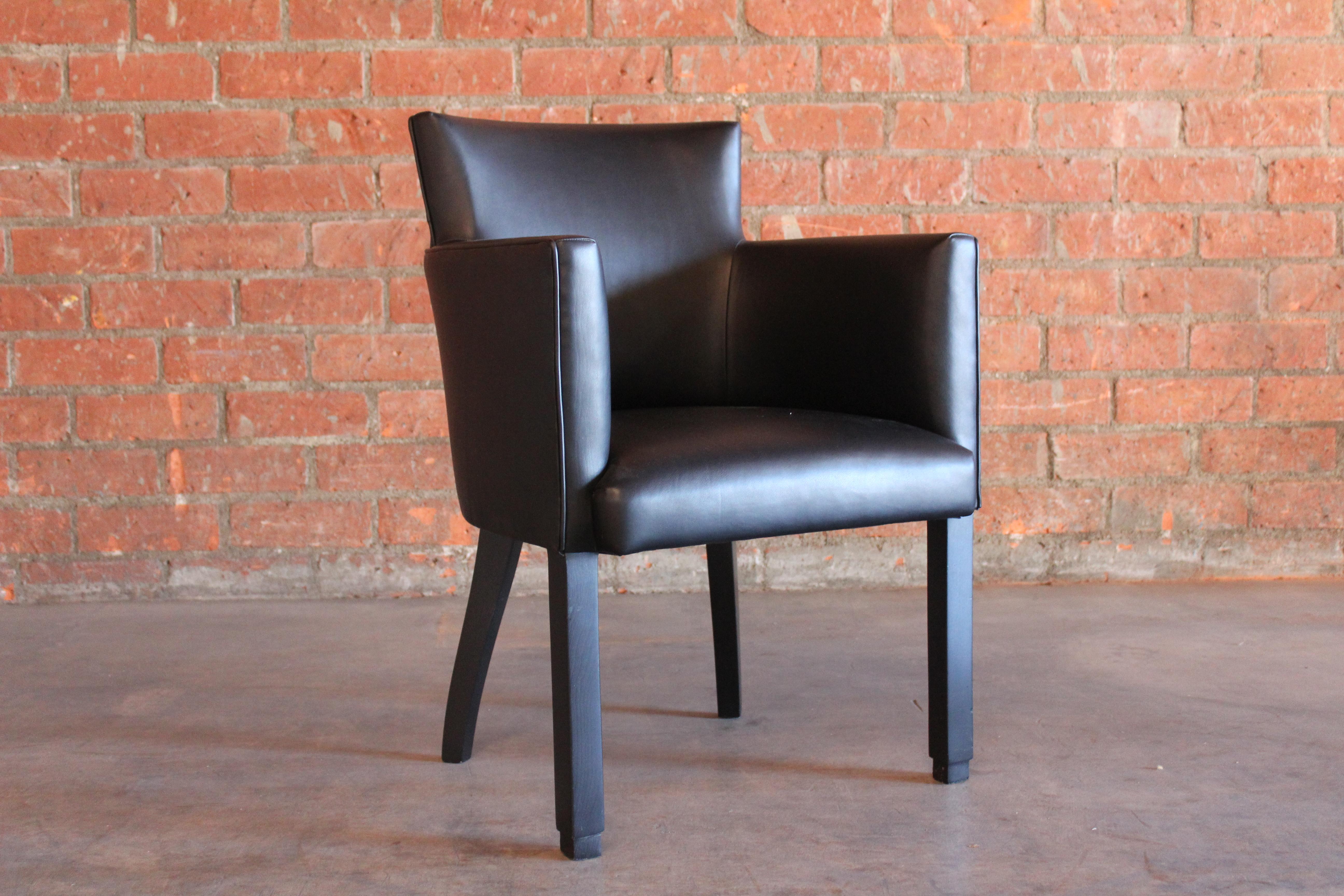 Vintage 1930s armchair in the manner of Jacques Adnet. Newly upholstered in genuine black leather. Wooden legs in a satin black finish. Measure: 26