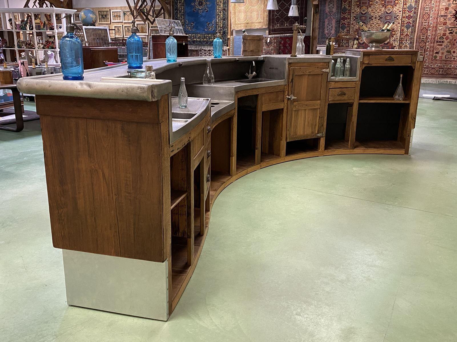 This is a fully restored 1930s French Art Deco bar. Tin curved counter top. Oak walnut wood base. This piece is 237