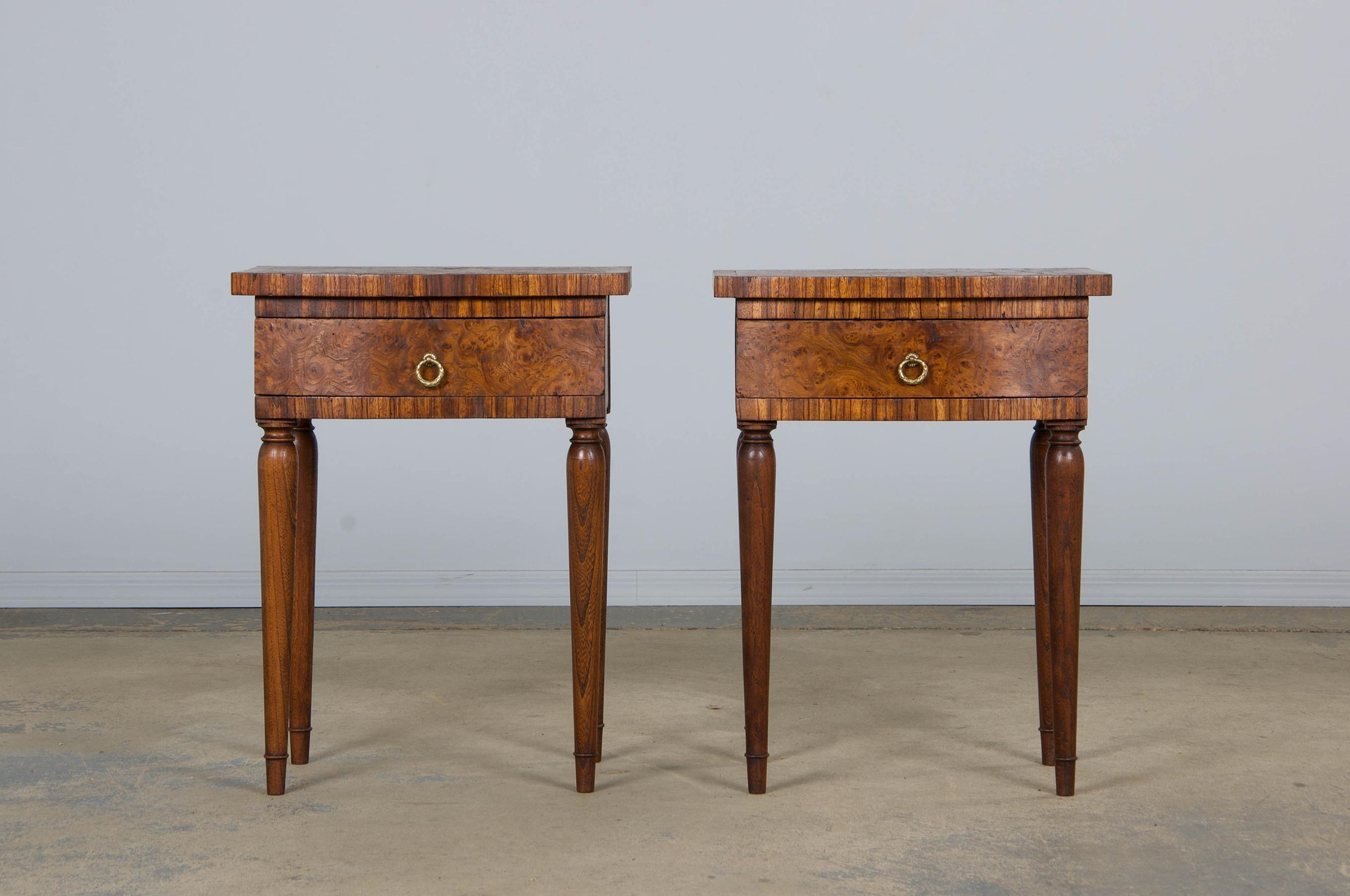 An elegant pair of 1930s French Art Deco nightstands or side tables sourced from Provence, France. Hand-crafted from solid walnut and decorated with a striking burl walnut veneer. The pieces have been structurally restored and gently refinished to