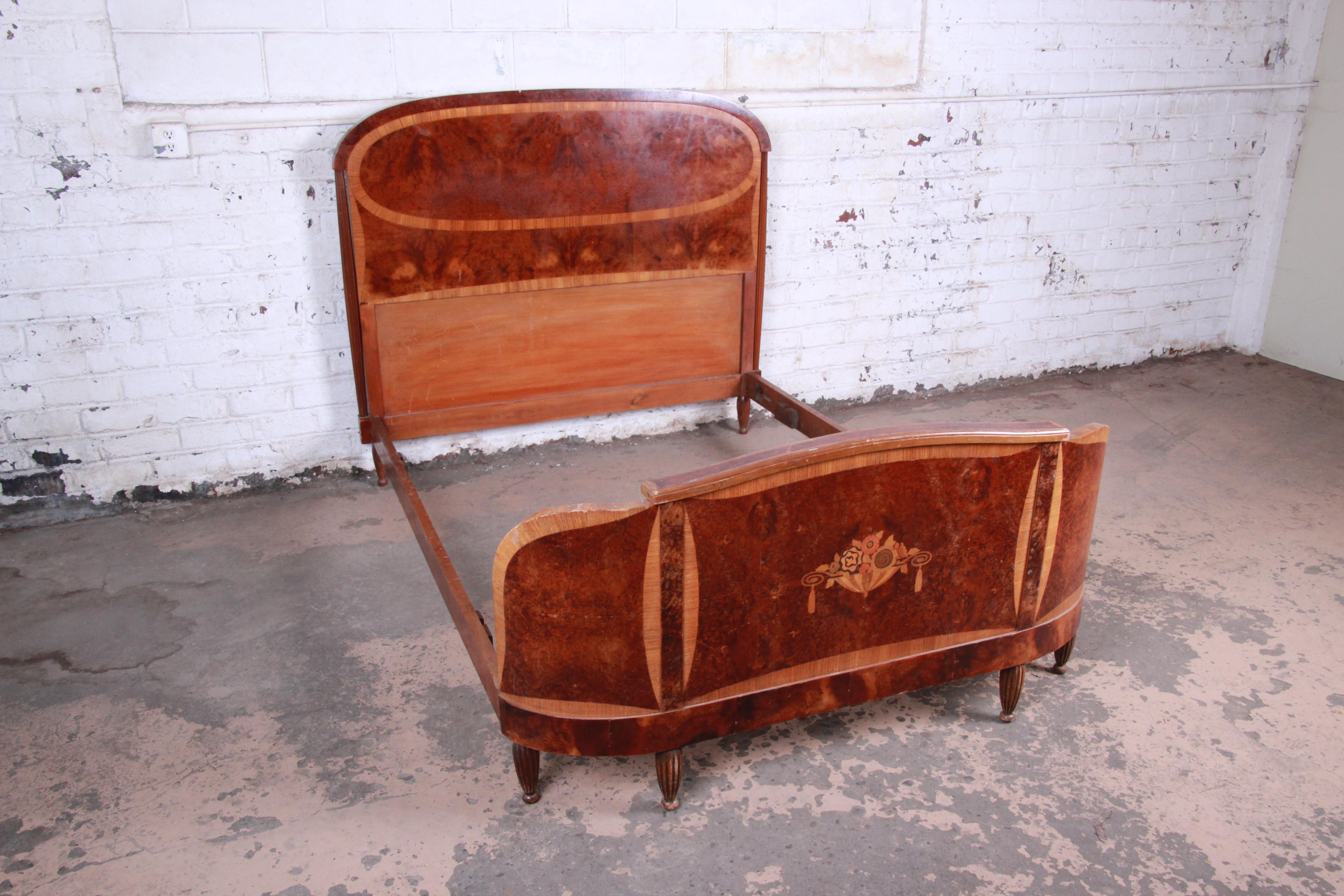 A gorgeous original 1930s French Art Deco bow front full size bed frame. The bed features stunning burl wood grain and inlaid marquetry. Recently imported from Southern France. This outstanding bed is sturdy and ready for use. It is in good original