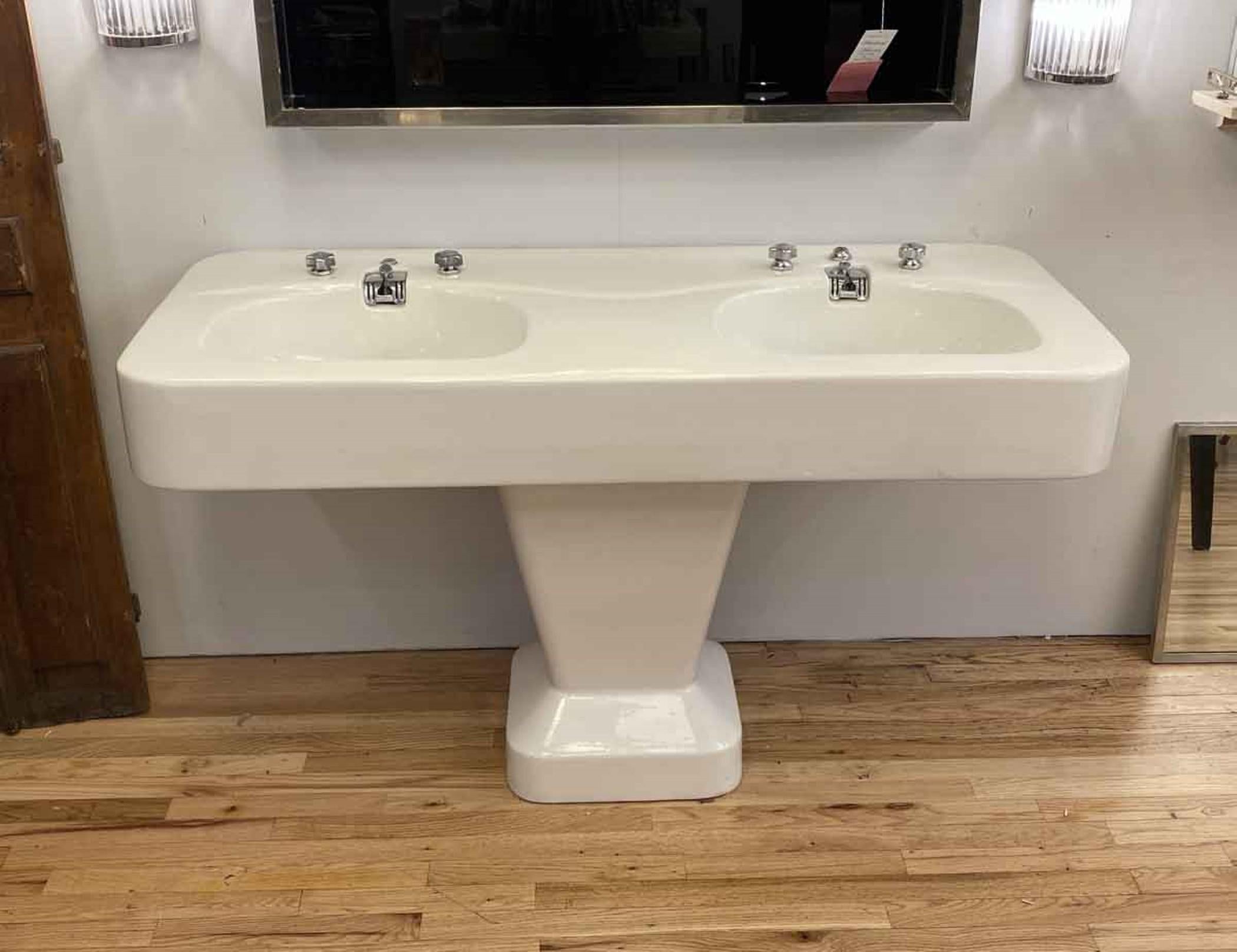 This extra wide French cast iron double basin porcelain sink is a rare find and in excellent condition. The original hardware is included. Geometric Art Deco wide pedestal provides a sturdy base to the double basin top. This was made in the