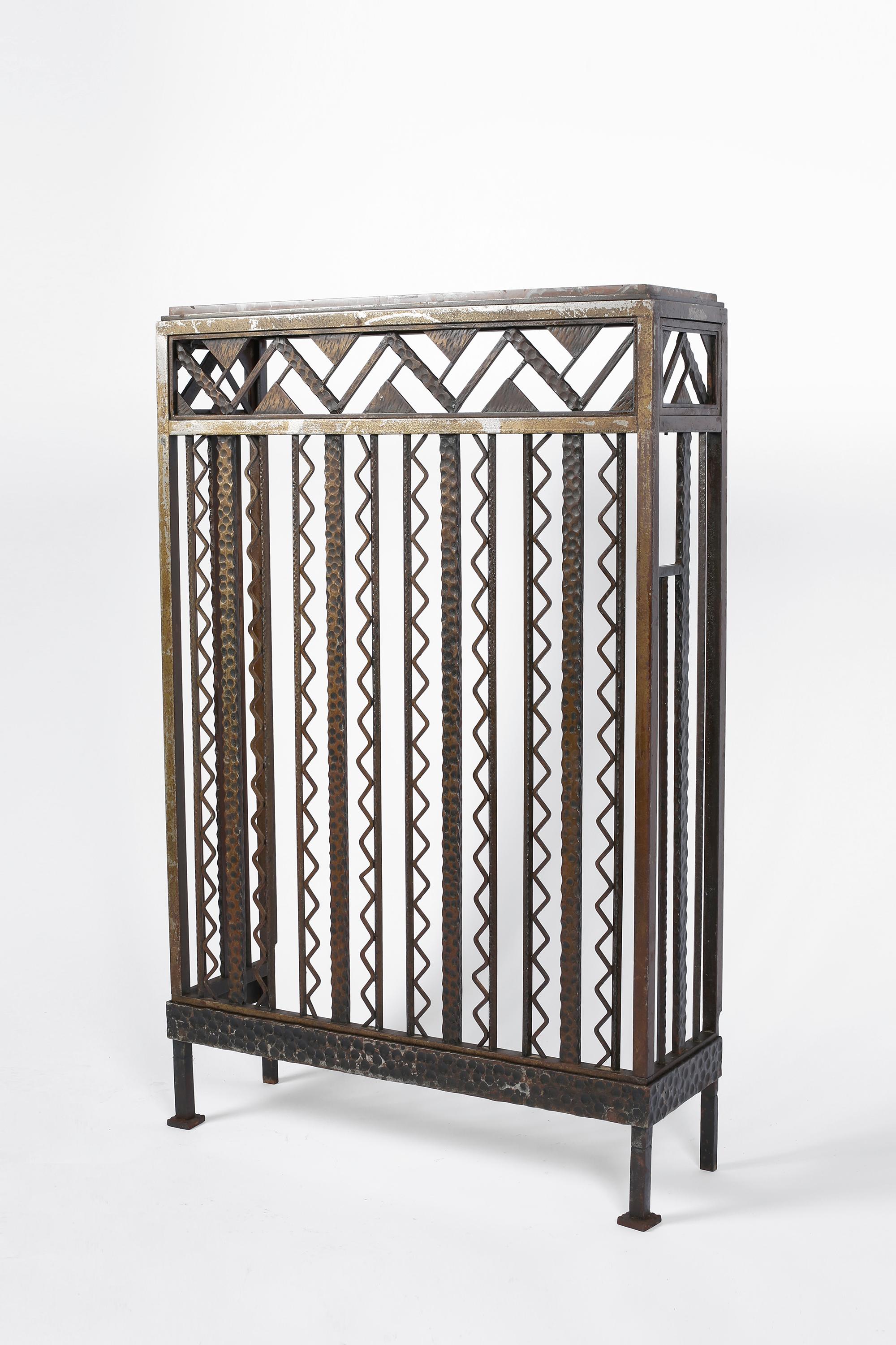 A fine Art Deco forged iron wall console table with original Pyrenean Griotte marble top. The geometric frieze decorated with differing hammer techniques, along with the vertical bars - punctuated by zig-zag detailing. Bold enough to be a