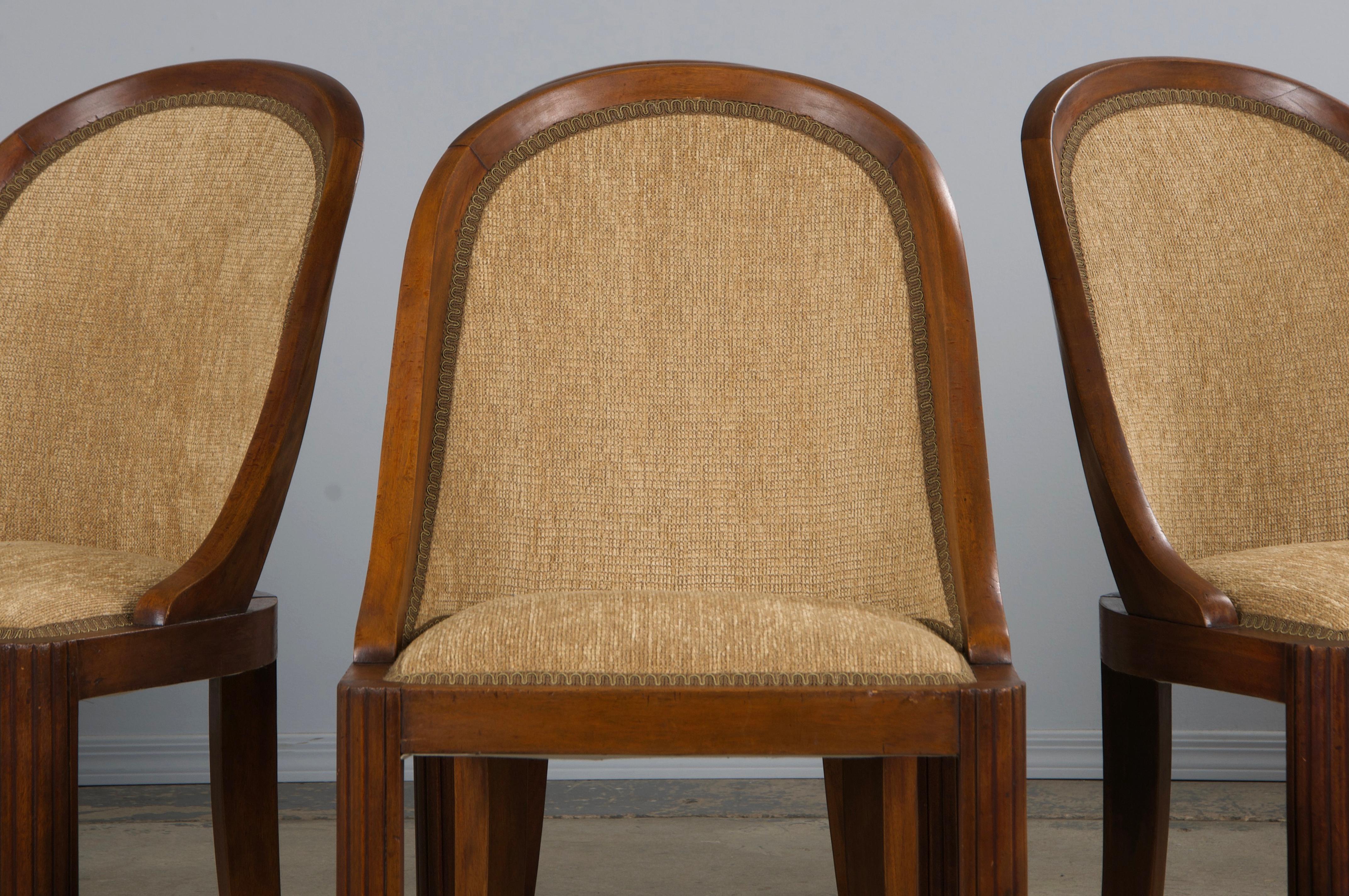 Uno squisito set di sei sedie da pranzo a gondola in stile Art Déco francese degli anni '30, provenienti dalla Provenza, in Francia. Sapientemente realizzata a mano in noce massiccio, ogni sedia presenta una ricca patina marrone invecchiata