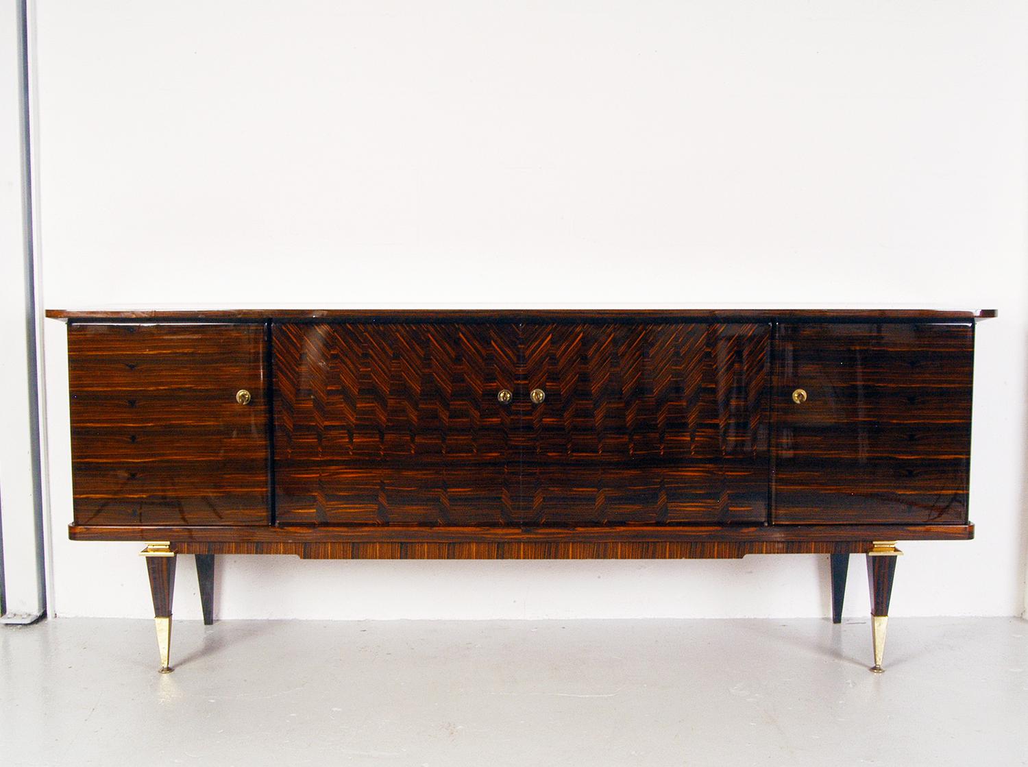 A wonderfully luxurious piece of Art Deco furniture from the days of high glamour. Beautifully designed and executed making full use of the striking grain pattern of Macassar Ebony. The interior of the piece is finished in lacquered maple. Three of