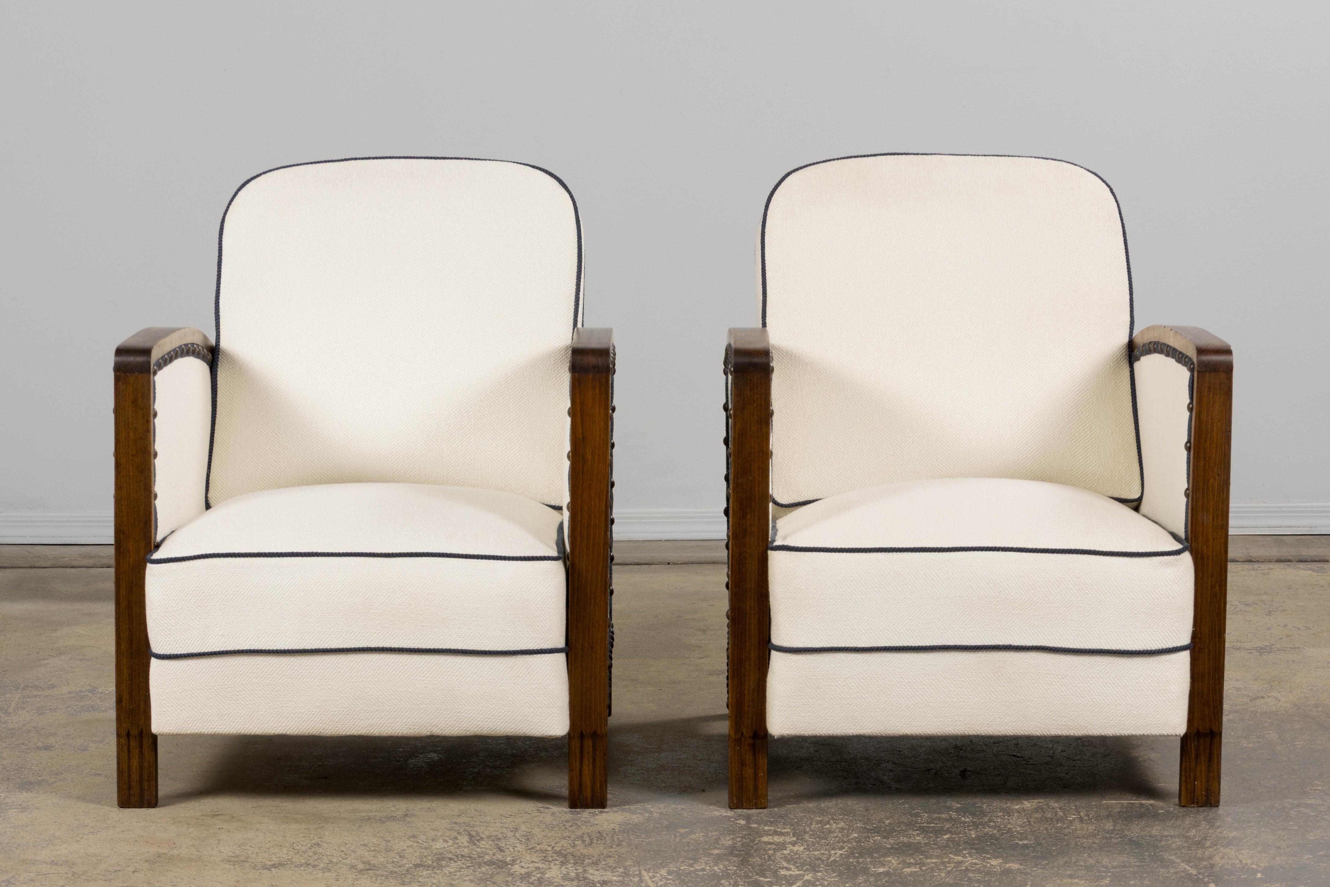 A handsome restored, pair of traditional 1930s French Art Deco club chairs sourced from Provence, France. Beautifully hand-crafted from solid maple wood. Each chairs features an elegant square-shaped back with rounded corners. Structurally restored