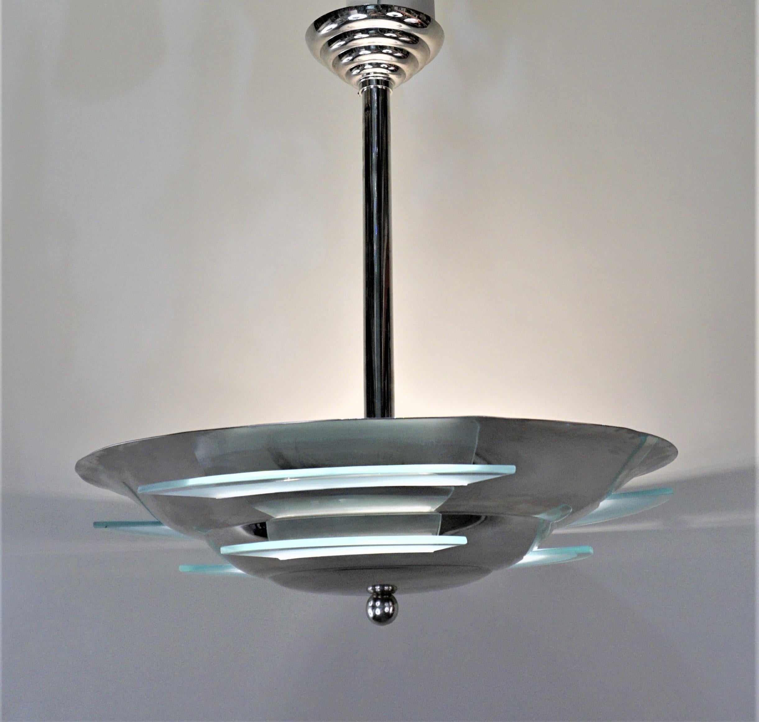 French Art Deco modern style nickel on bronze with clear and frost glass chandelier.
Total of 9 lights 60 watt max each.
