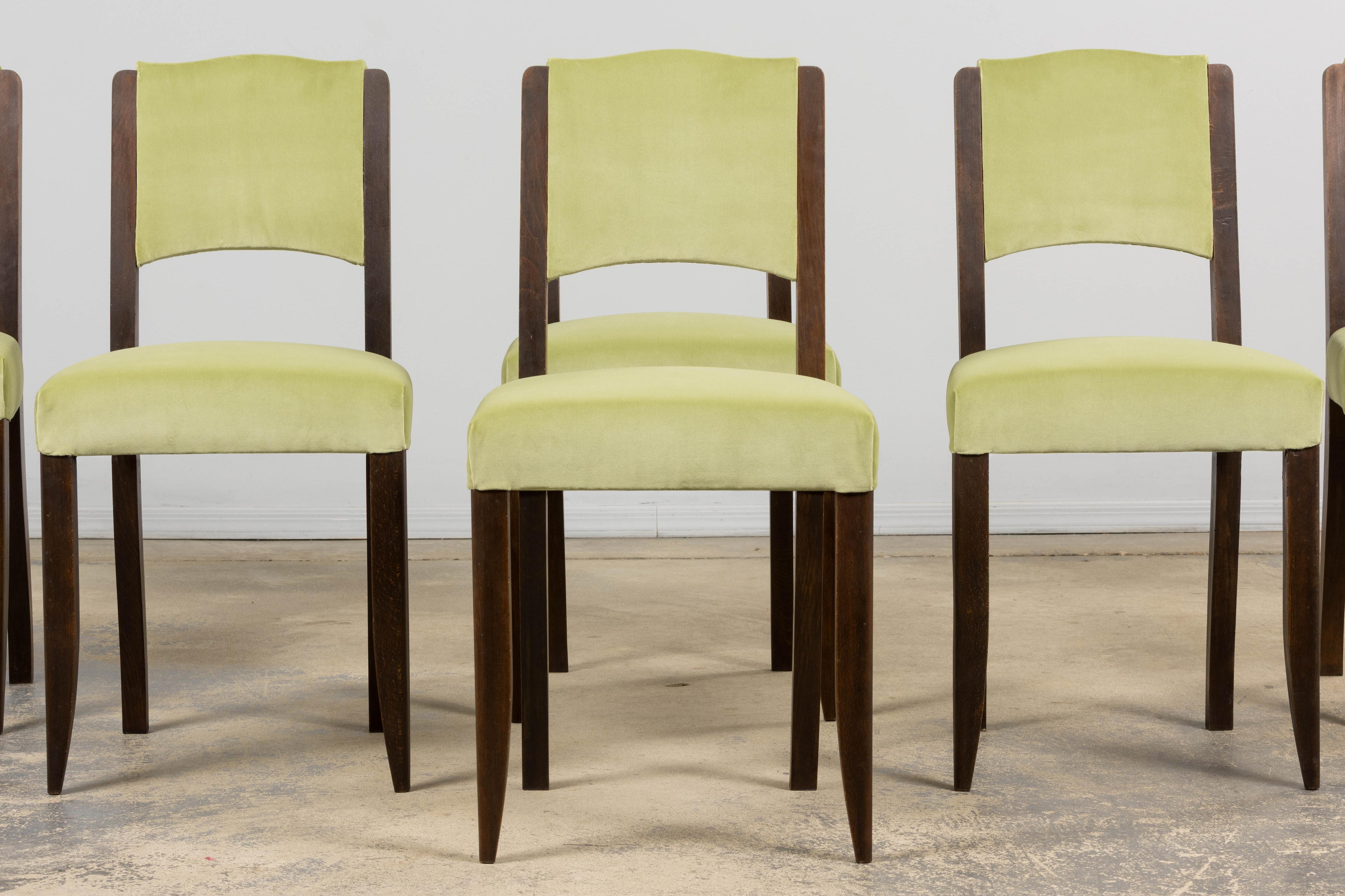 A beautifully restored set of six French Art Deco dining chairs dating to the late 1930s, sourced in France. Crafted in oak, each chair shows a clean, linear silhouette with subtly rounded uprights and gently tapered legs - classic elements of the