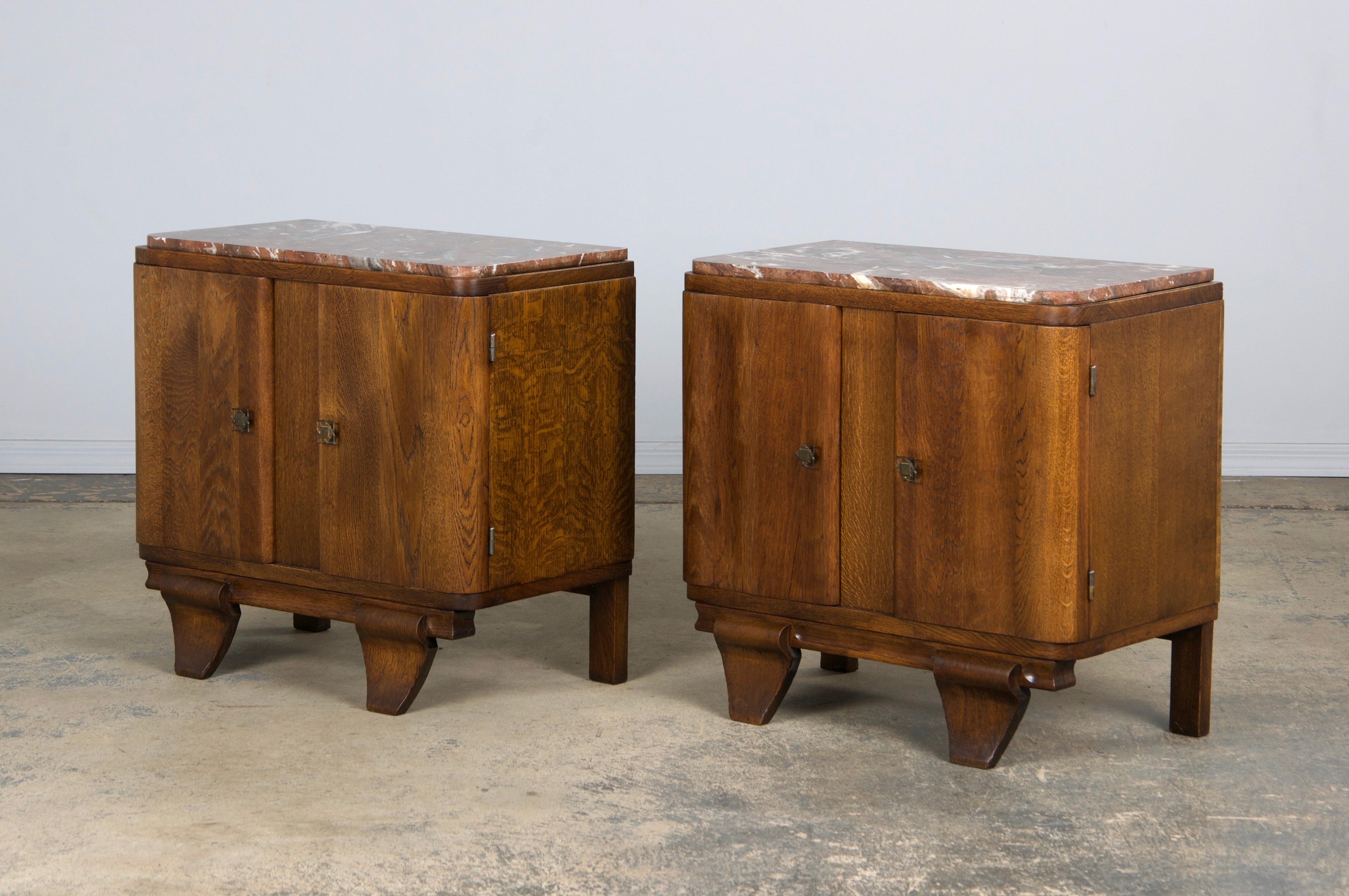 A charming pair of 1930s French Art Deco nightstands or side tables, sourced from Provence and beautifully handcrafted from solid oak. Each piece is topped with its original red marble, adding elegance and contrast to the warm brown oak beneath.
