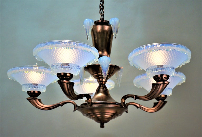 Opalescent glass known as dripping icicles or frozen ice by Ezan one of the best French glass makers from the 1930s with copper finish frame chandelier.
 