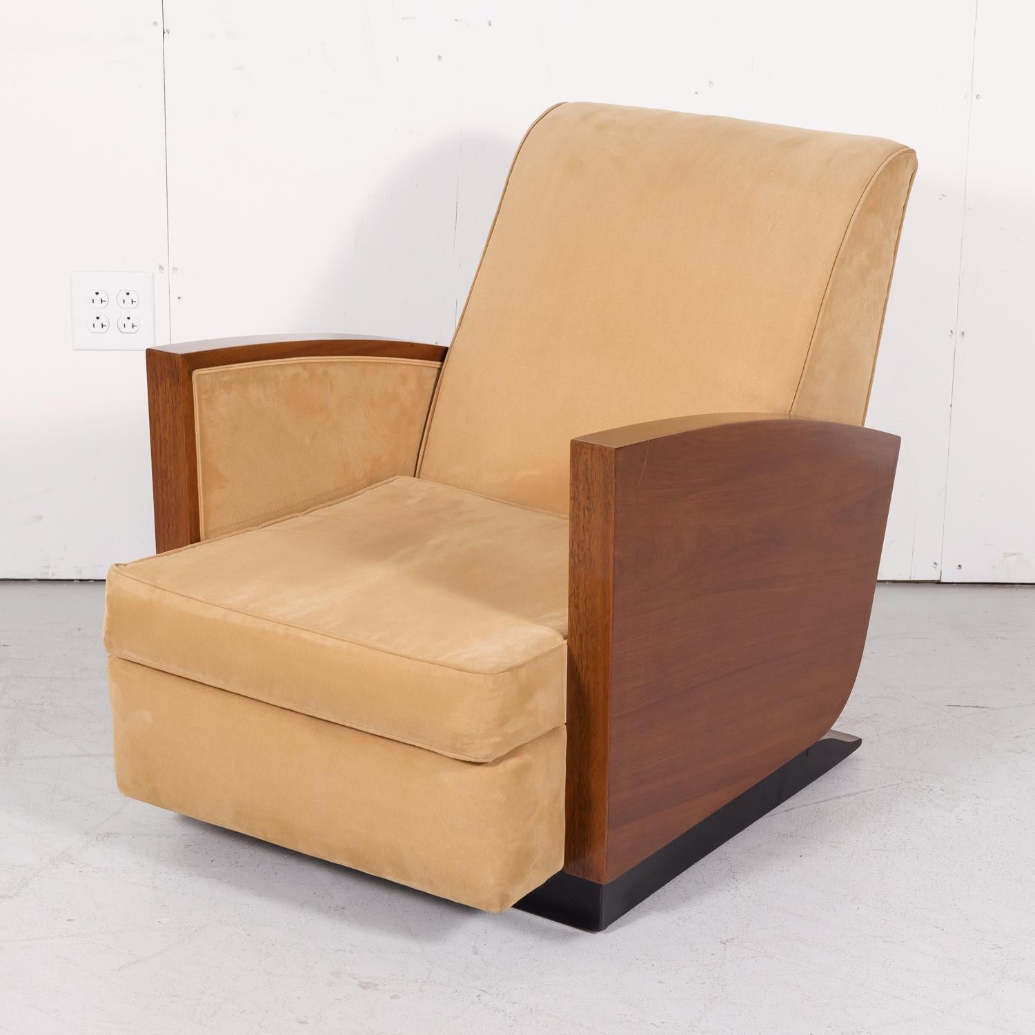 French Art Deco period armchair in walnut with a black lacquered base and ski slope arms, circa 1930s. Upholstered in a fine tan corduroy, this rare lounge chair with loose cushion is perhaps the most comfortable armchair we've ever had. The epitome