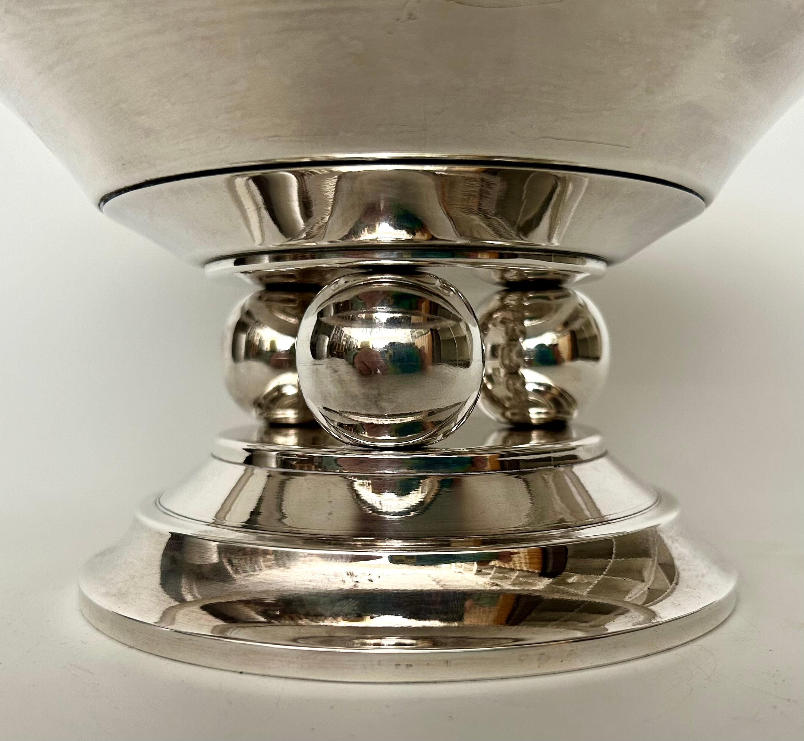 A large 1930s French Art Deco centrepiece in silverplate, with a wide dish sitting above three spheres and a stepped base, bearing the hallmark of Francois Frionnet, one of the master Silversmiths of the period.

Dimensions: H 14.5cm x D