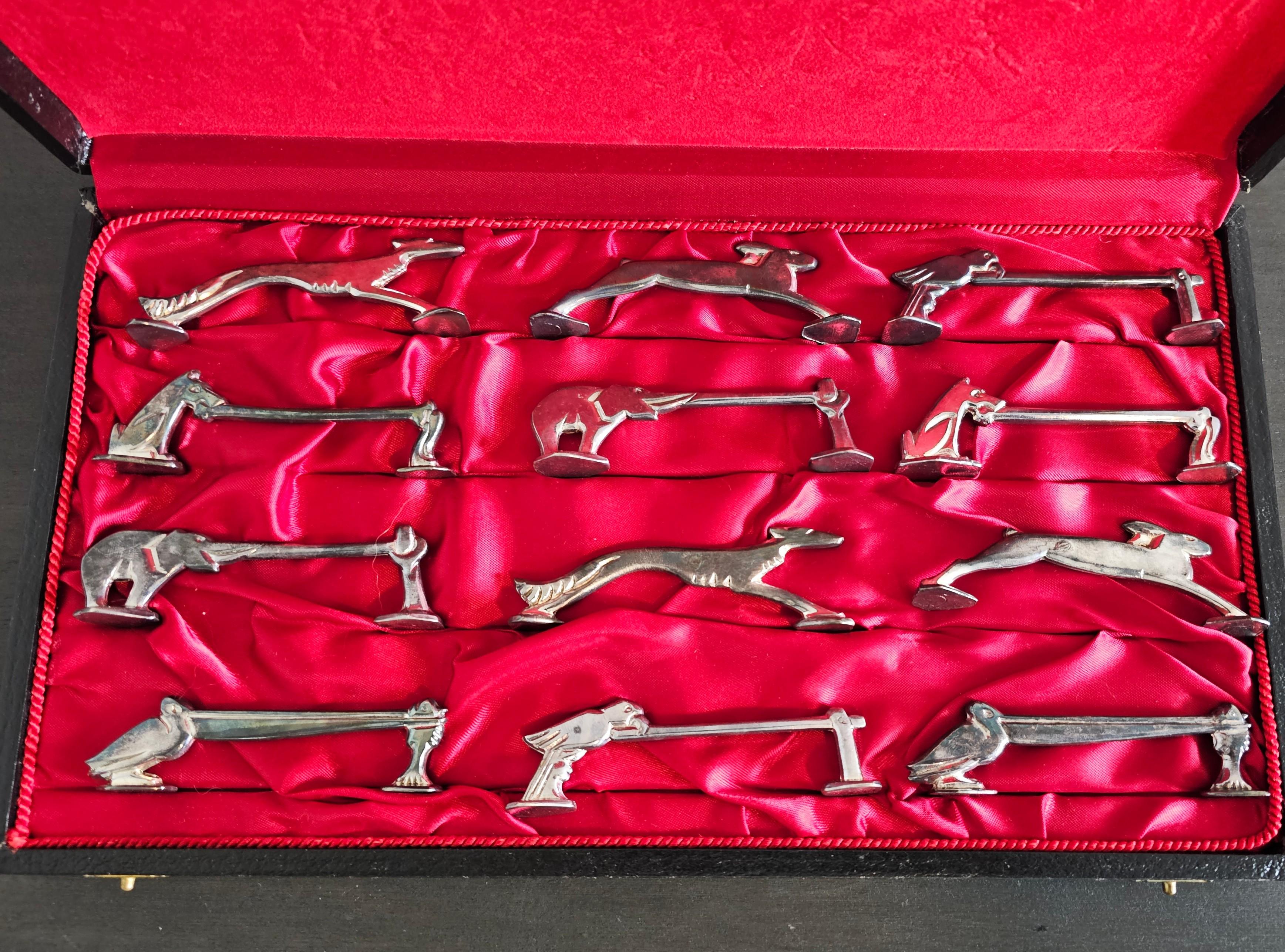 Add a touch of whimsical elegance and sophistication to your dinner party with this boxed set of twelve fine French Art Deco silver plated figural animal knife rests. circa 1930s

Born in France in the early/mid-20th century, styled in the manner