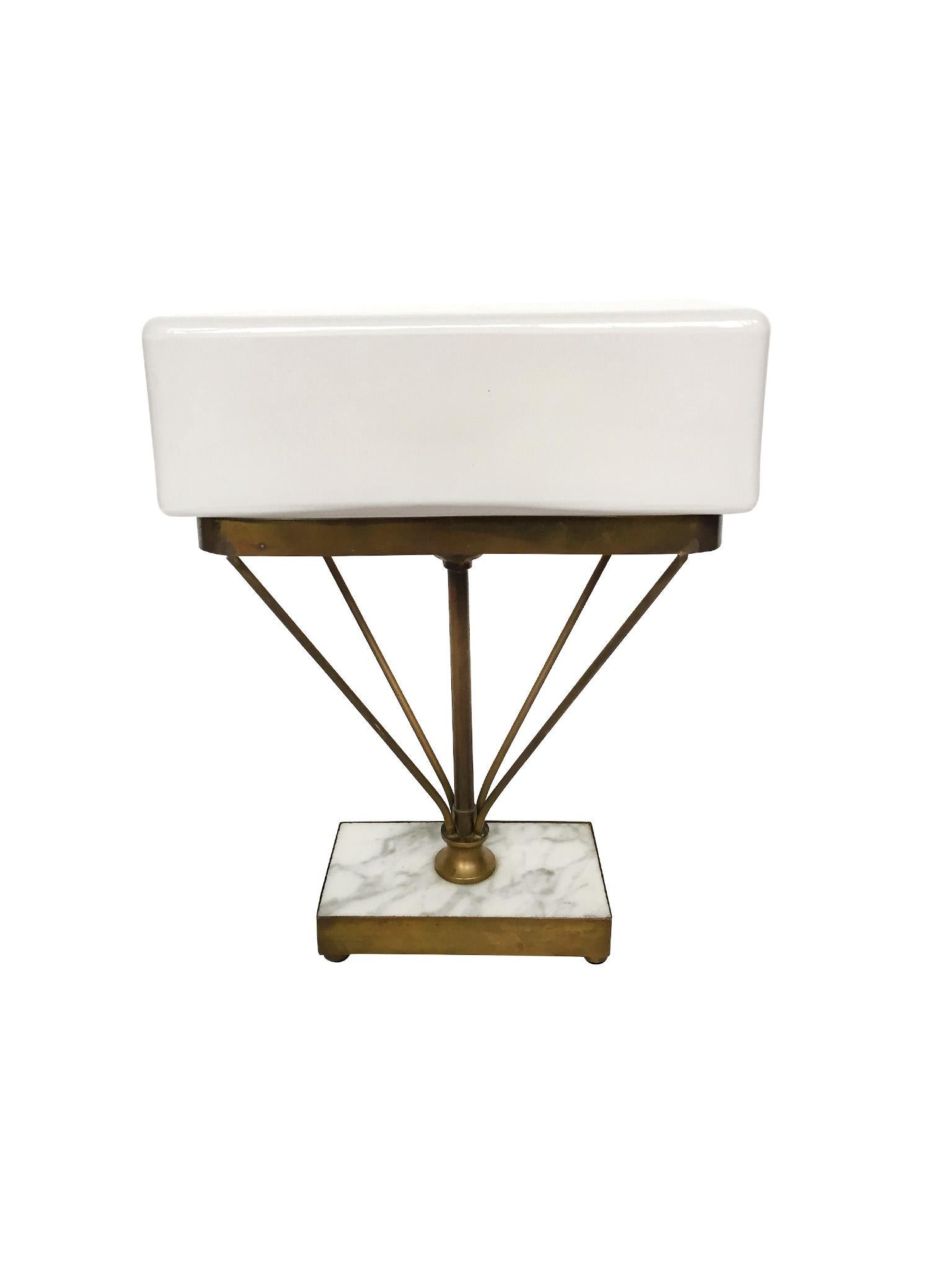 This small table lamp was created in the 1930s in the manner of the Art Deco and modernist architect and designer, Jacques Adnet, renowned for his luxe and minimal designs in metal and glass. This particular table lamp emulates Adnet's use of simple