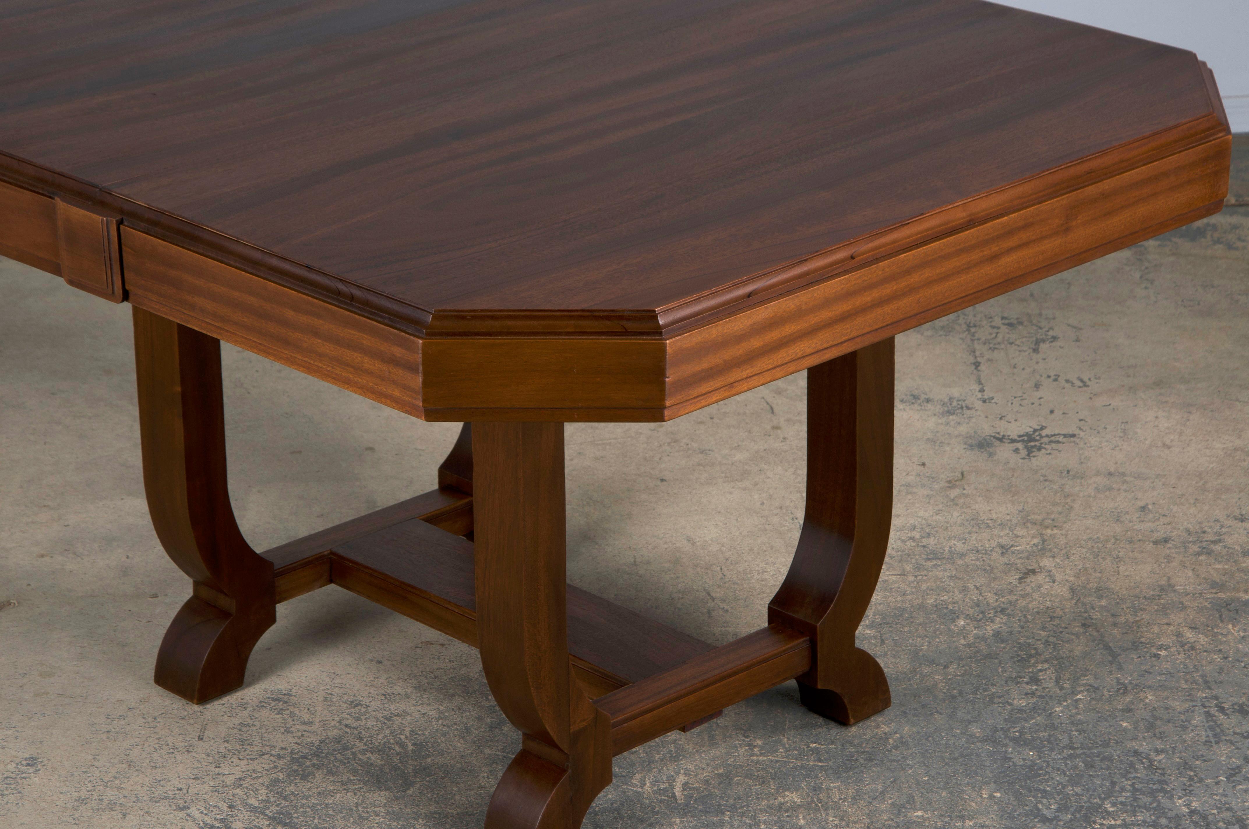 A traditional 1930s French Art Deco dining table sourced from Provence, France. Beautifully hand-crafted from solid walnut wood and constructed with a rectangular top featuring a beveled edge and squared corners. The wood showcases a naturally aged