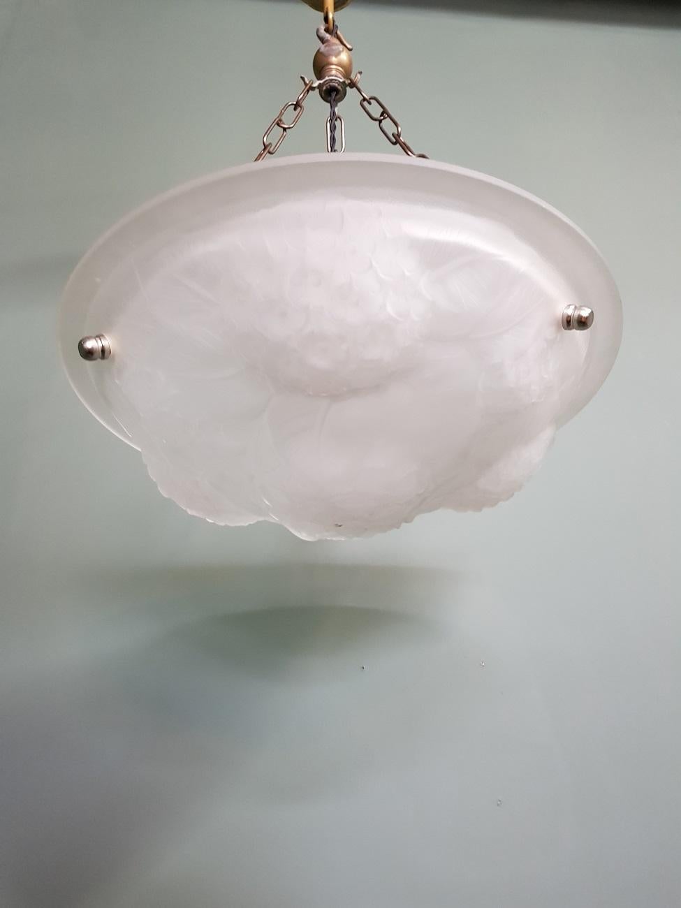 French Art Deco Glass dish pendant with relief in the form of flowers and leaves, rewired and made in the 1930s.

The measurements are:
Depth 35 cm/ 13.7 inch.
Width 35 cm/ 13.7 inch.
Height 64 cm/ 25.1 inch.