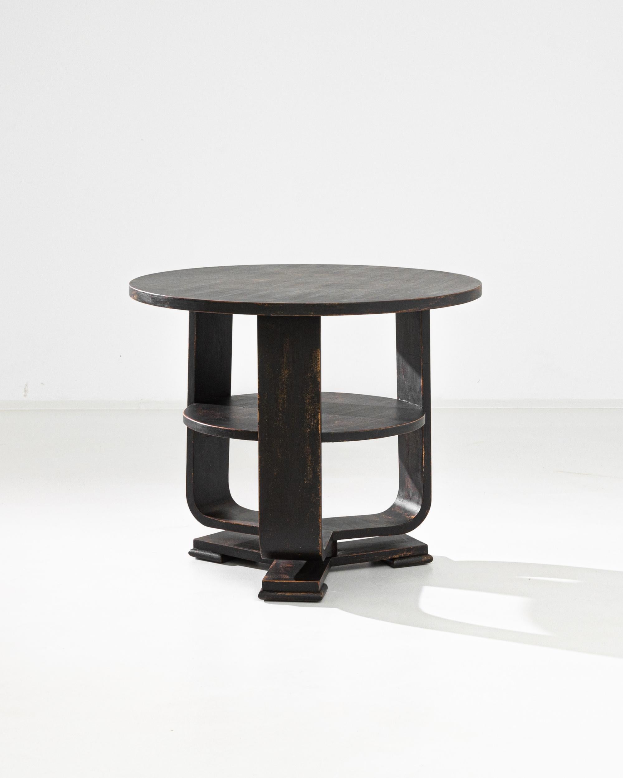 A black patinated wooden table from France, produced circa 1930. A characteristic Art Deco side table stands as a chic statement.