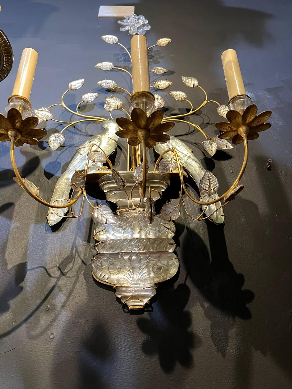 A pair of circa 1930's French gilt metal sconces with parrot's design and glass leaves. With 3 lights