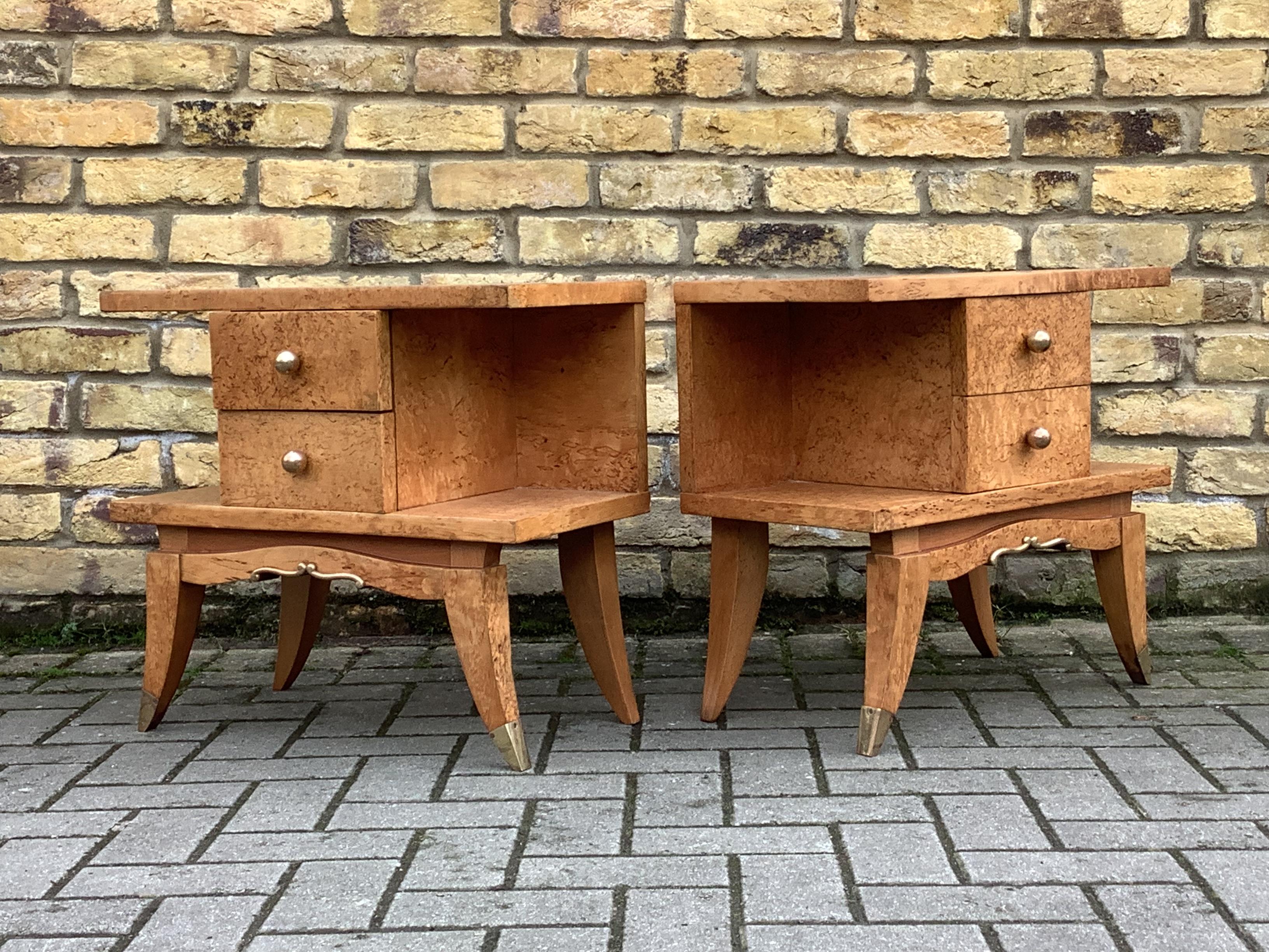 Beautiful pair of French Deco bedside cabinets restored and polished to bring out the stunning grain .Two storage draws
With wonderfully shaped legs with brass tips.