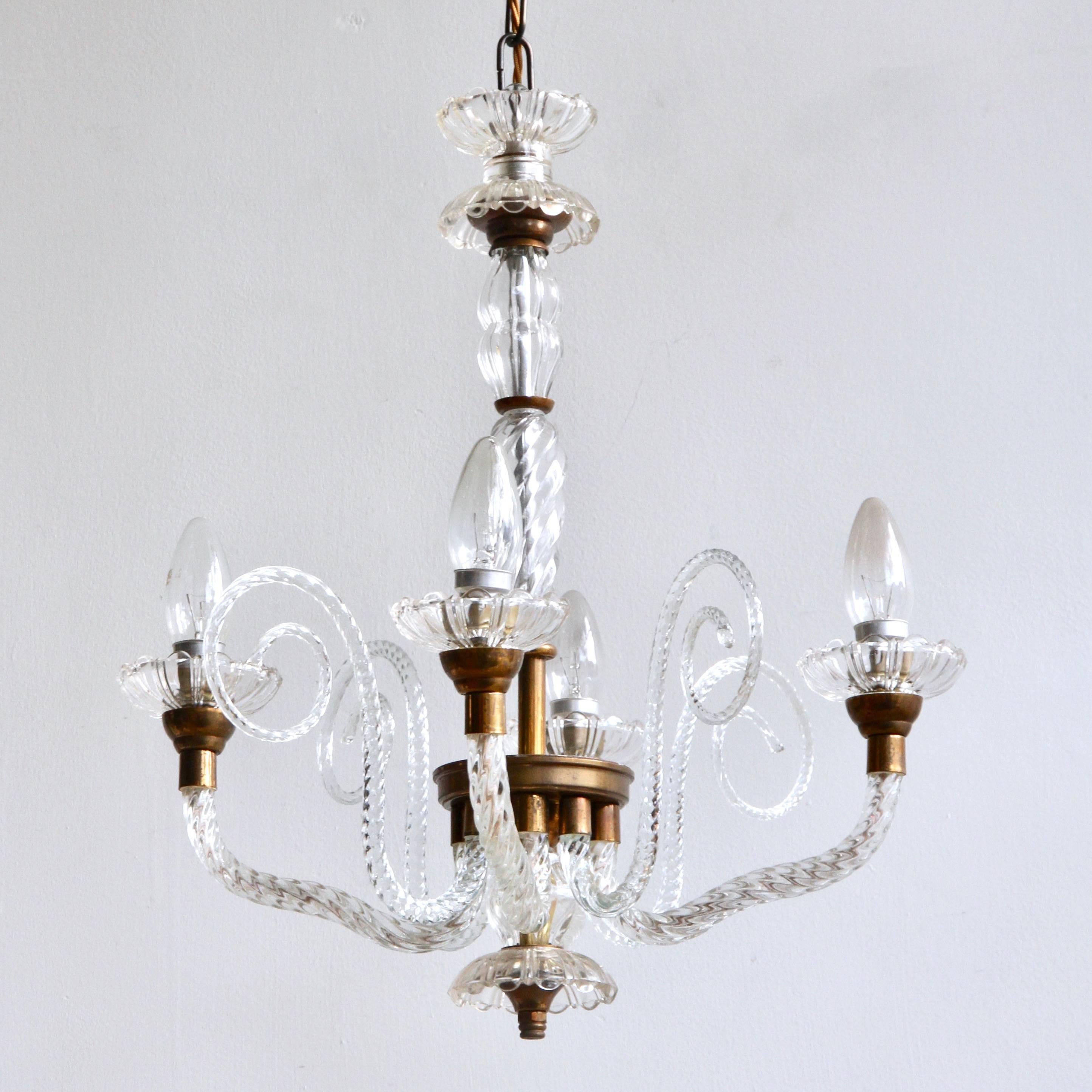 A four branch French glass chandelier dating from the 1930s. A beautifully proportioned chandelier with elegant details. The angle of the arms are unusual and are slightly elongated. There are four walking sticks with scrolling glass swirls in