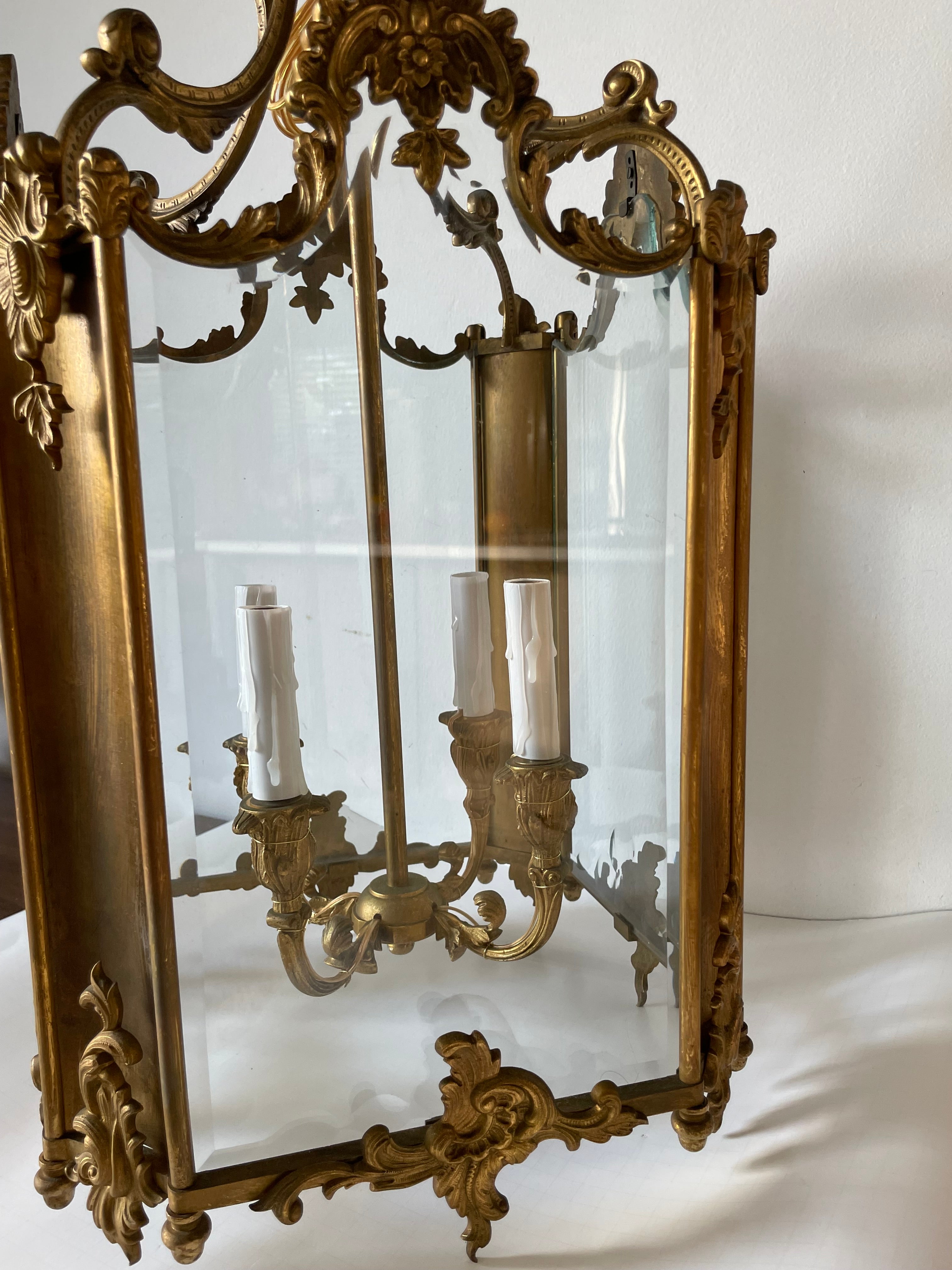 Beautiful bronze lantern with baroque decoration. Four sides in beveled glass, four candles in the center. Rewired for Us standard.