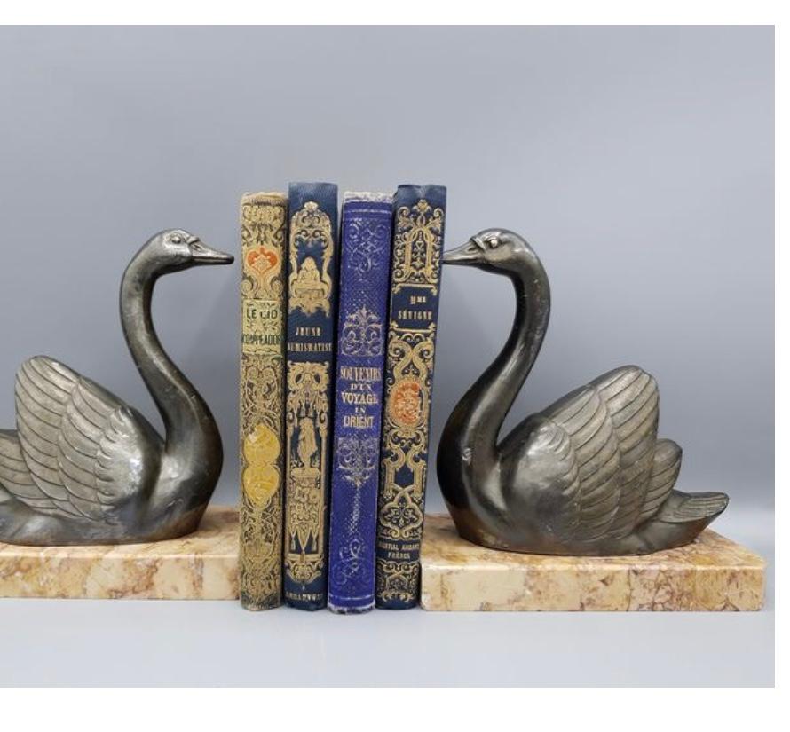 1930s French by M. Leducq Art Deco Swans with marble bases bookends

Large pair of Babbitt metal bookends with grey patina depicting swans, beige marble base. Perfect as bookends or desk paper weights. Signed 