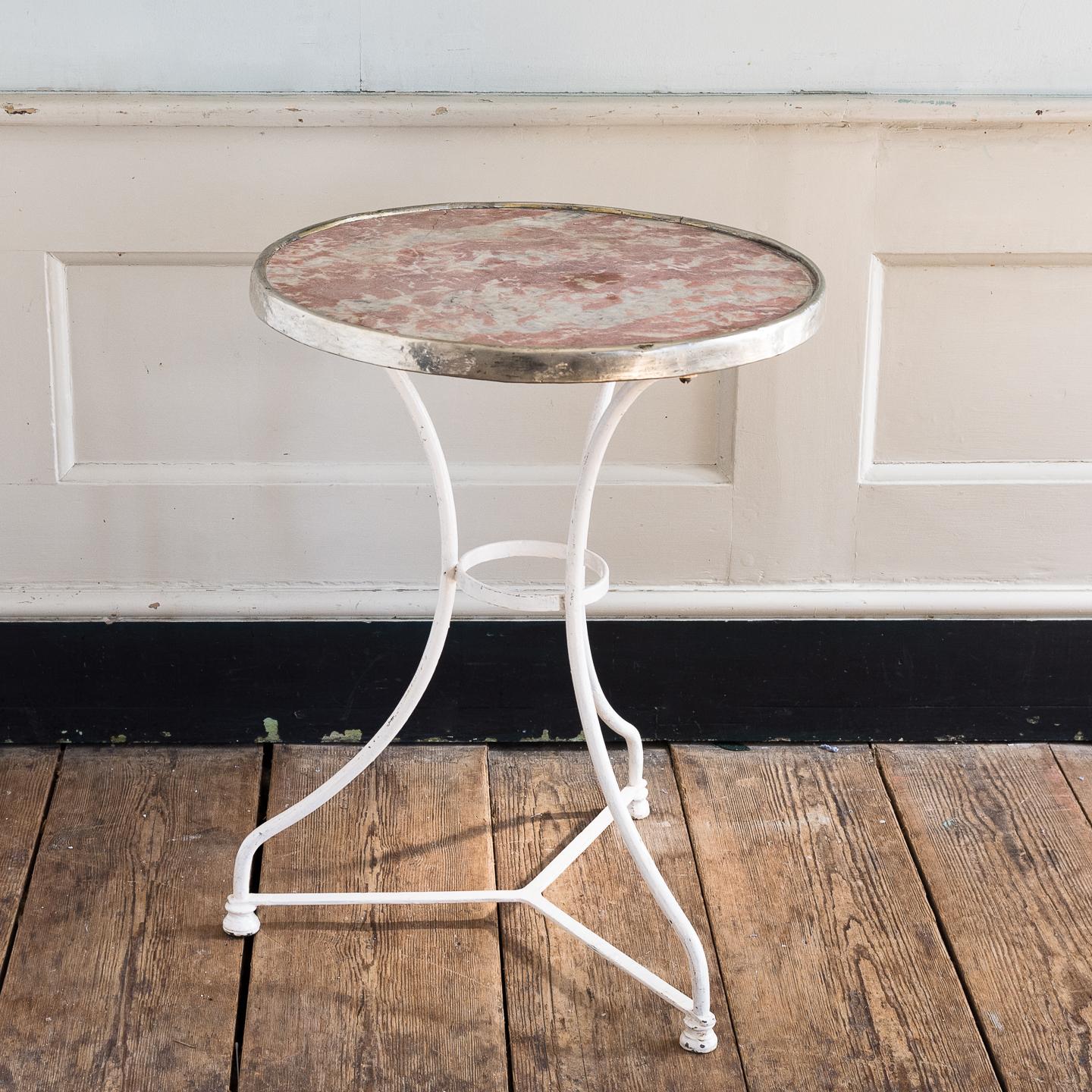 A 1930s French cafe table, the Rouge Languedoc marble top with nickel rim, on white painted iron base.
 