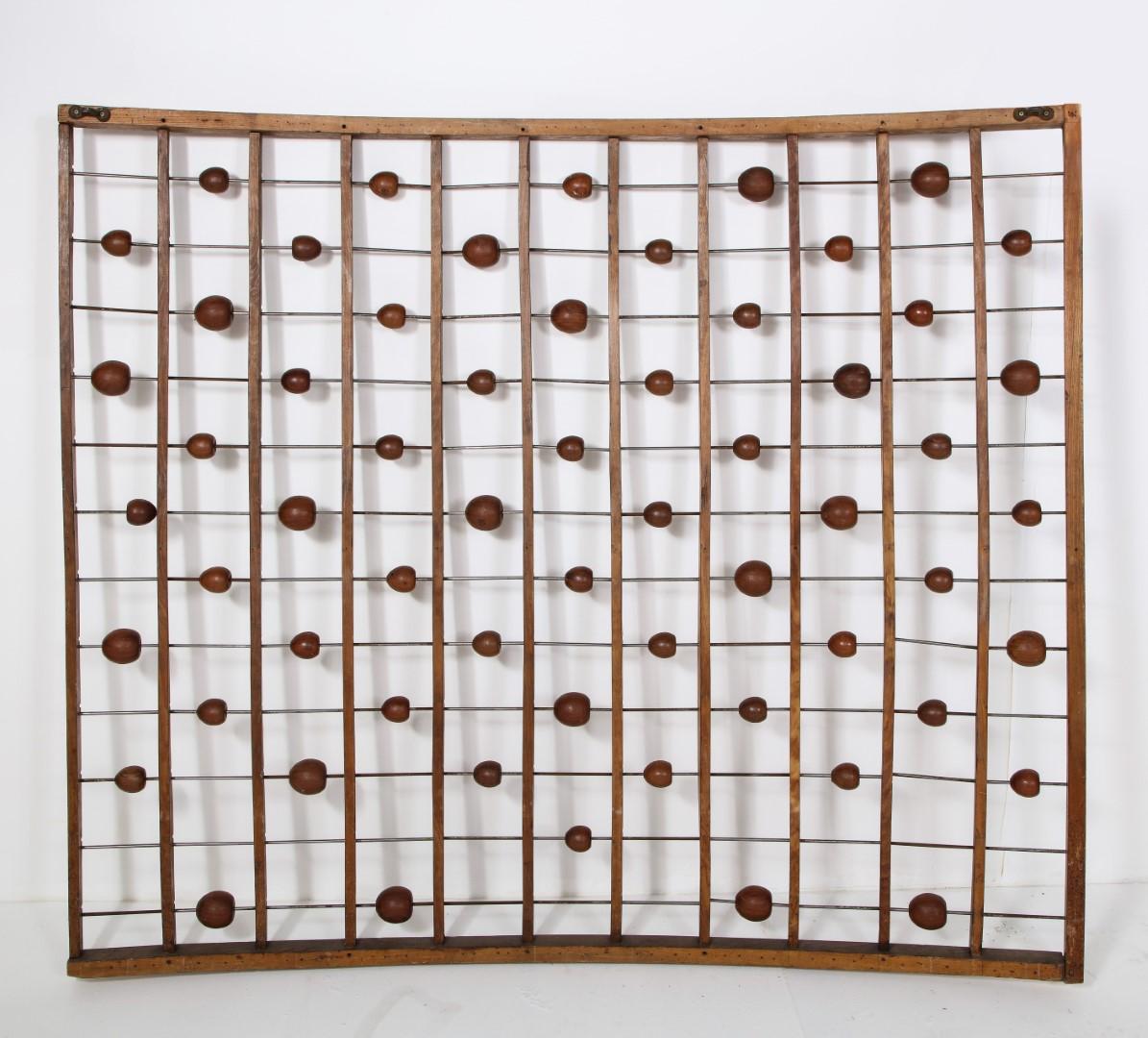 French carved oak curved wood and iron abacus-style folk art, circa 1930s. Provenance: Marche Paul Bert in Paris. Smooth carved wooden balls of varying sizes are held with iron pins which are easily movable to make the pattern customized. The pins