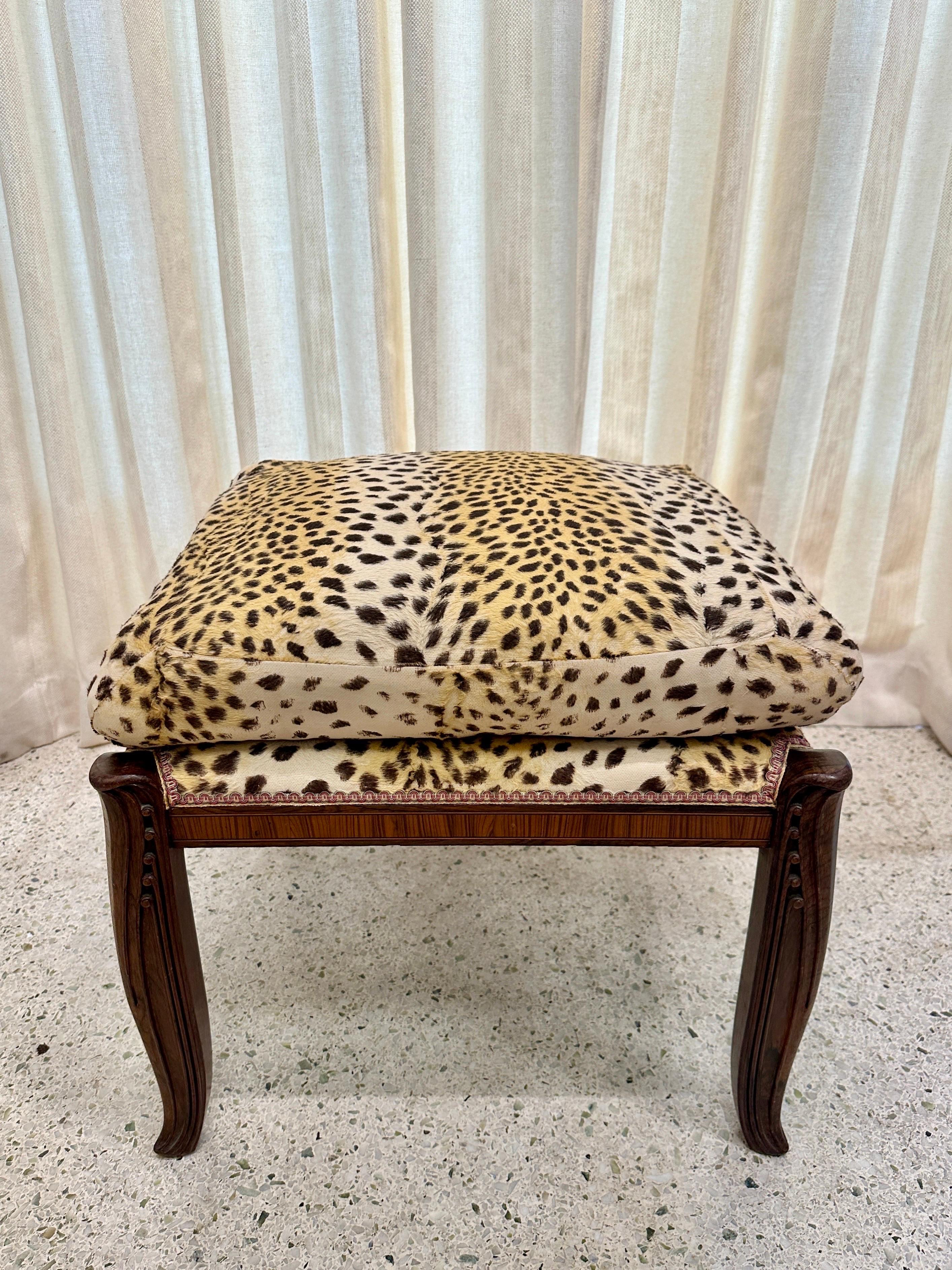 This is a wonderful Art Deco period stool/ bench with original cheetah print fabric and carved ebony wood legs, marquetry inlay trim throughout.  It is sturdy, perfect height and features beautiful art deco details (see all detail images and video).