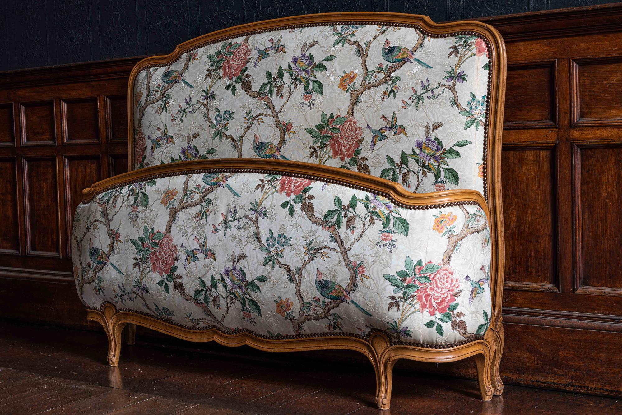 1930s French demi Corbeille double bed with decorative upholstery
The decorative nature inspired upholstery with birds and blossom branches is in very good condition showing minor signs of wear.

Measures: Internal 144 D x 190 W (180 to rail) 196