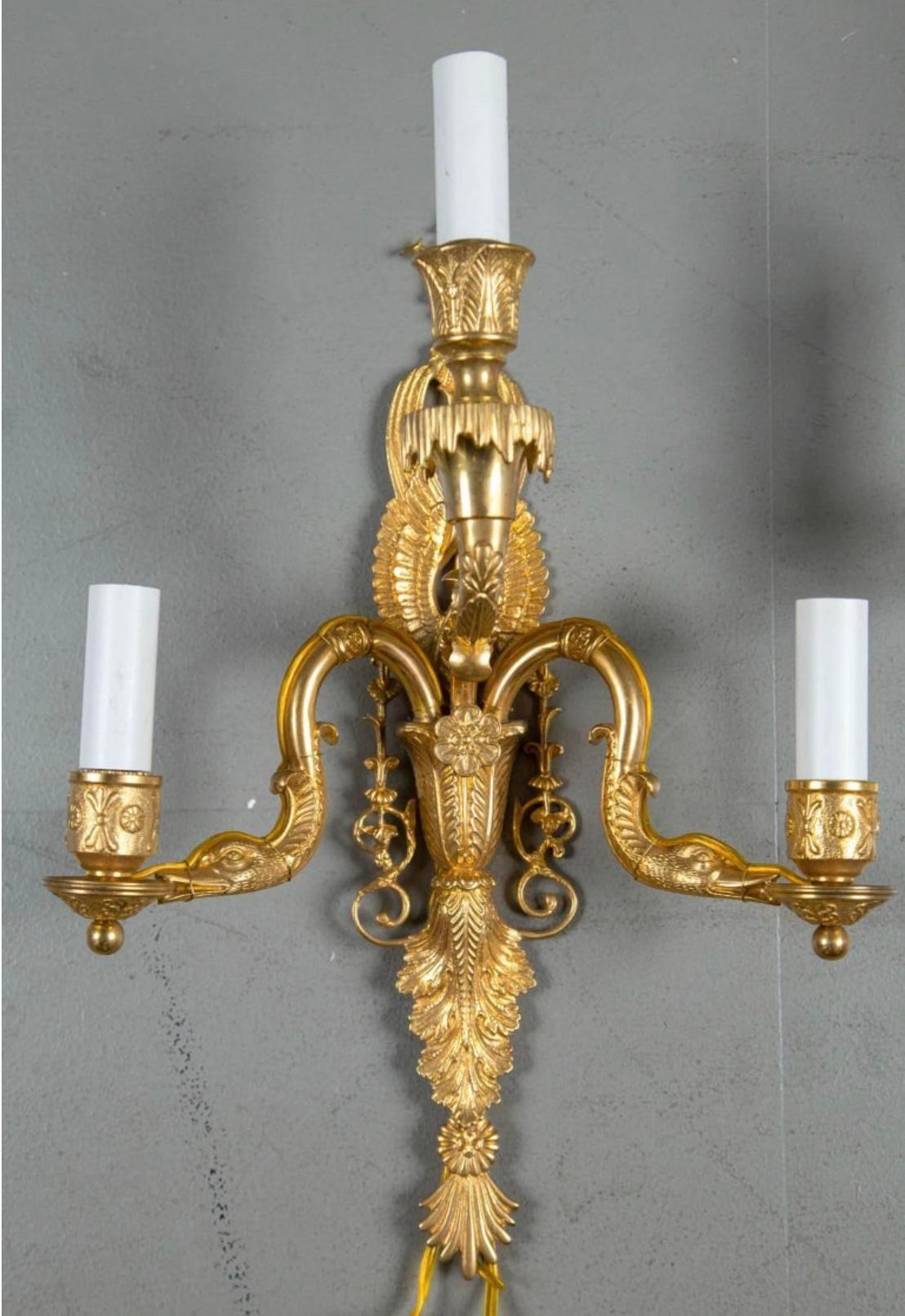 A pair of circa 1930 French empire style three lights sconces with swan heads