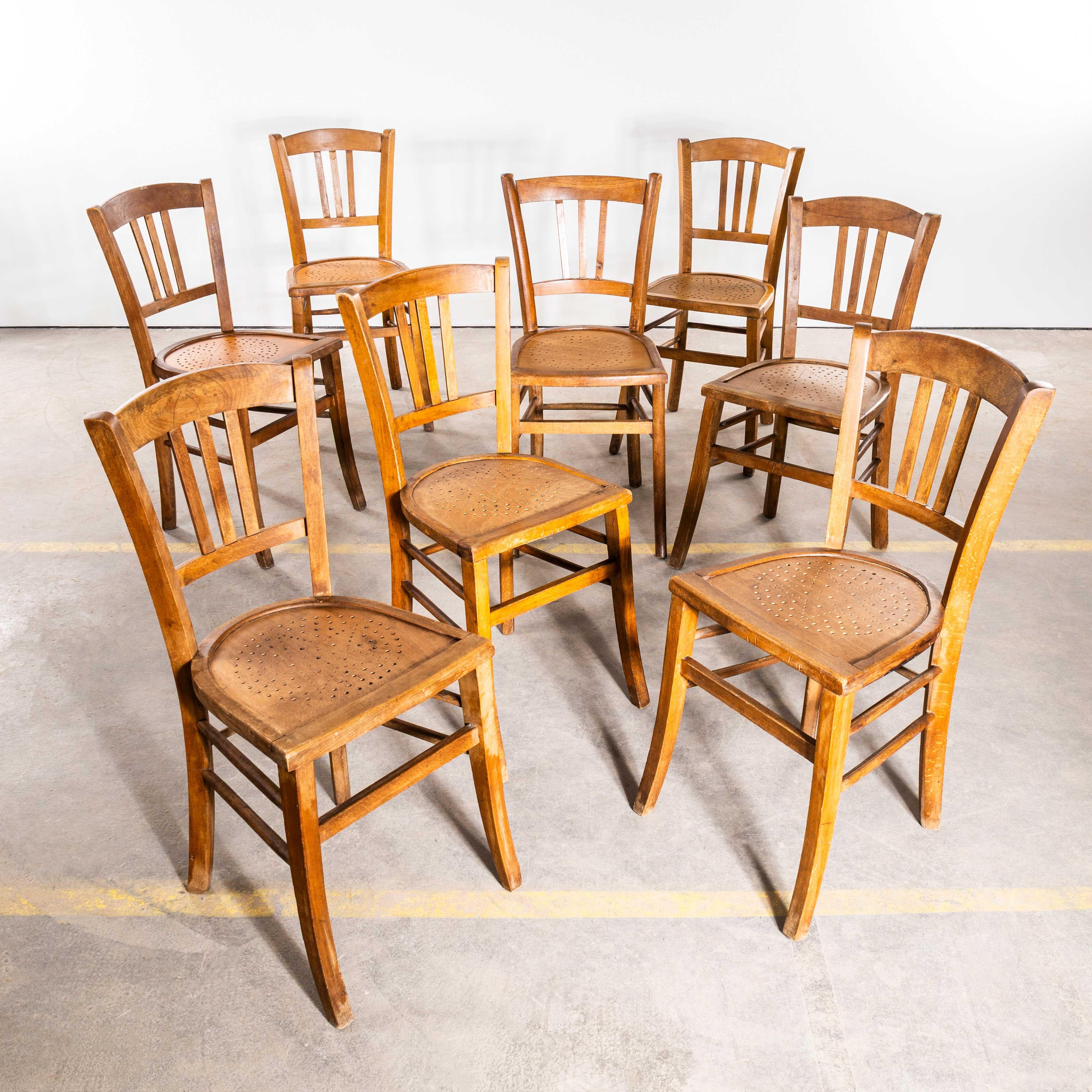 1930's French Farmhouse Perforated Seat Dining Chairs - Set Of Eight. Die Stühle stammen aus Südfrankreich und sind sehr originell und ungewöhnlich, leider ohne Herstellerzeichen. Wir haben diese exakte Form und den geprägten Sitz noch nie gesehen,