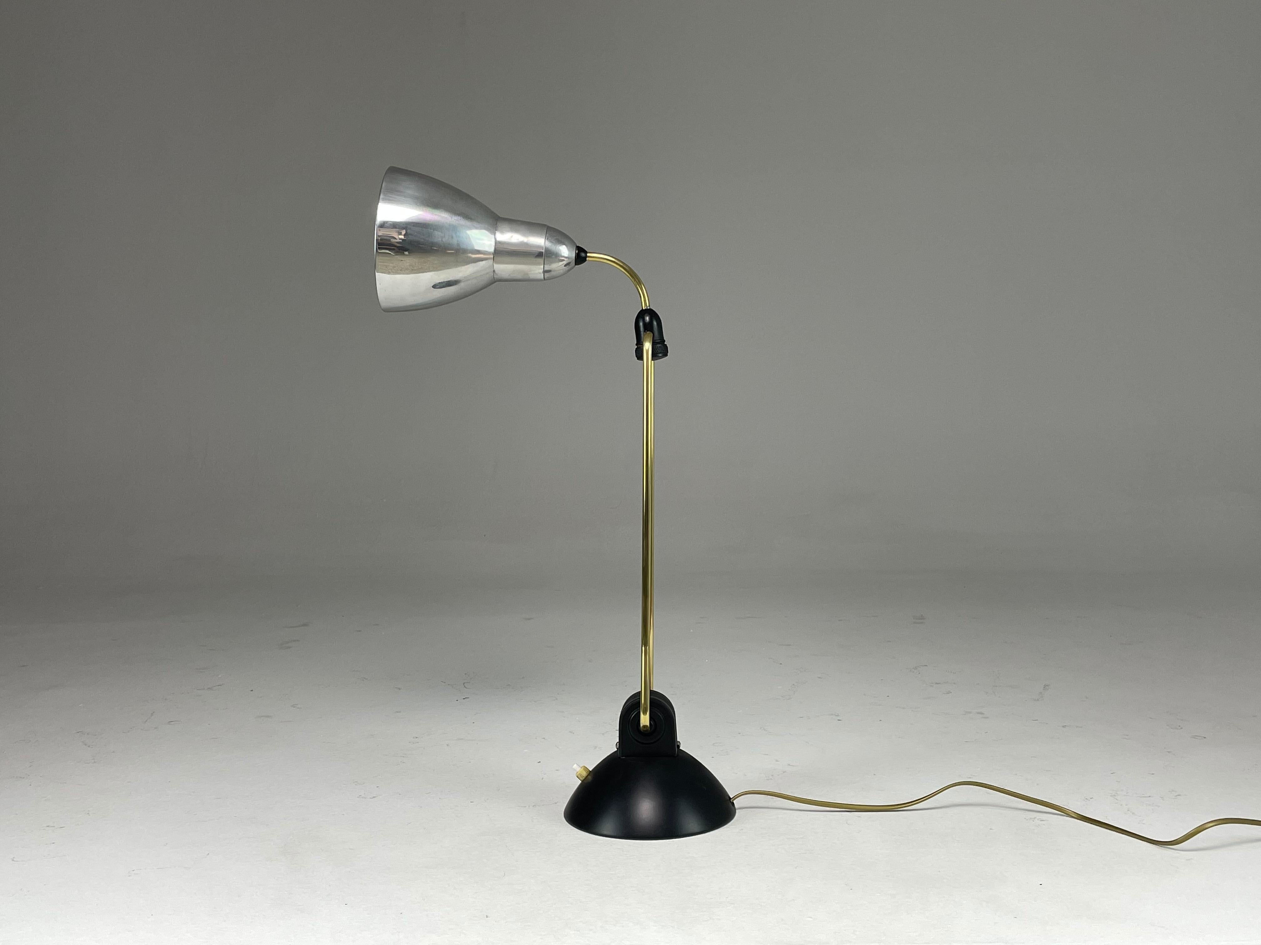 A cool 20th-century industrial French table or desk light produced in the 1930's. This piece stands out through its sophisticated design, adjustability and quality materials (aluminium, steel and brass). 
Fully restored, professionally re-wired,