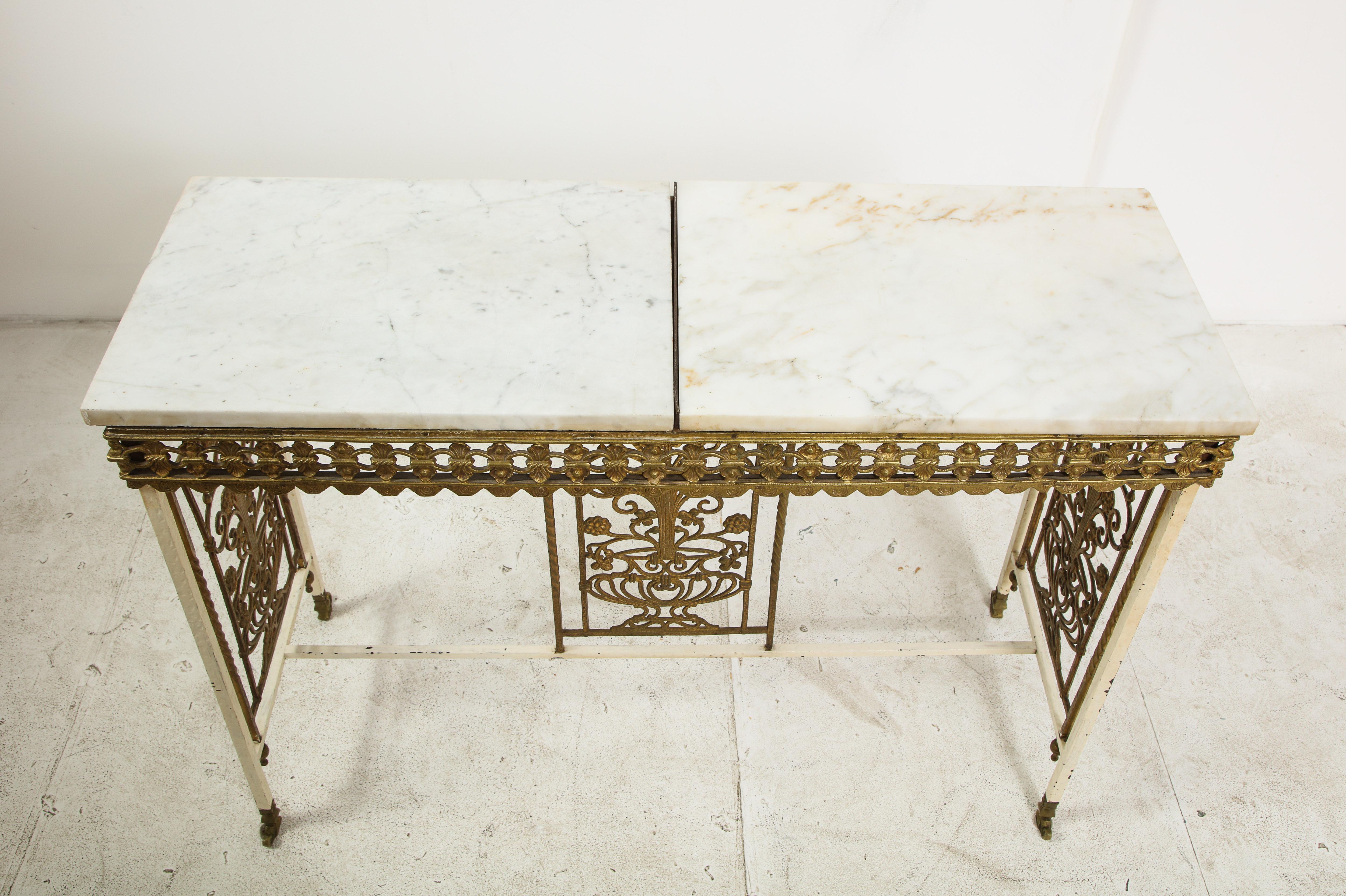 1930s French painted iron console with gilt details and two-piece marble top.