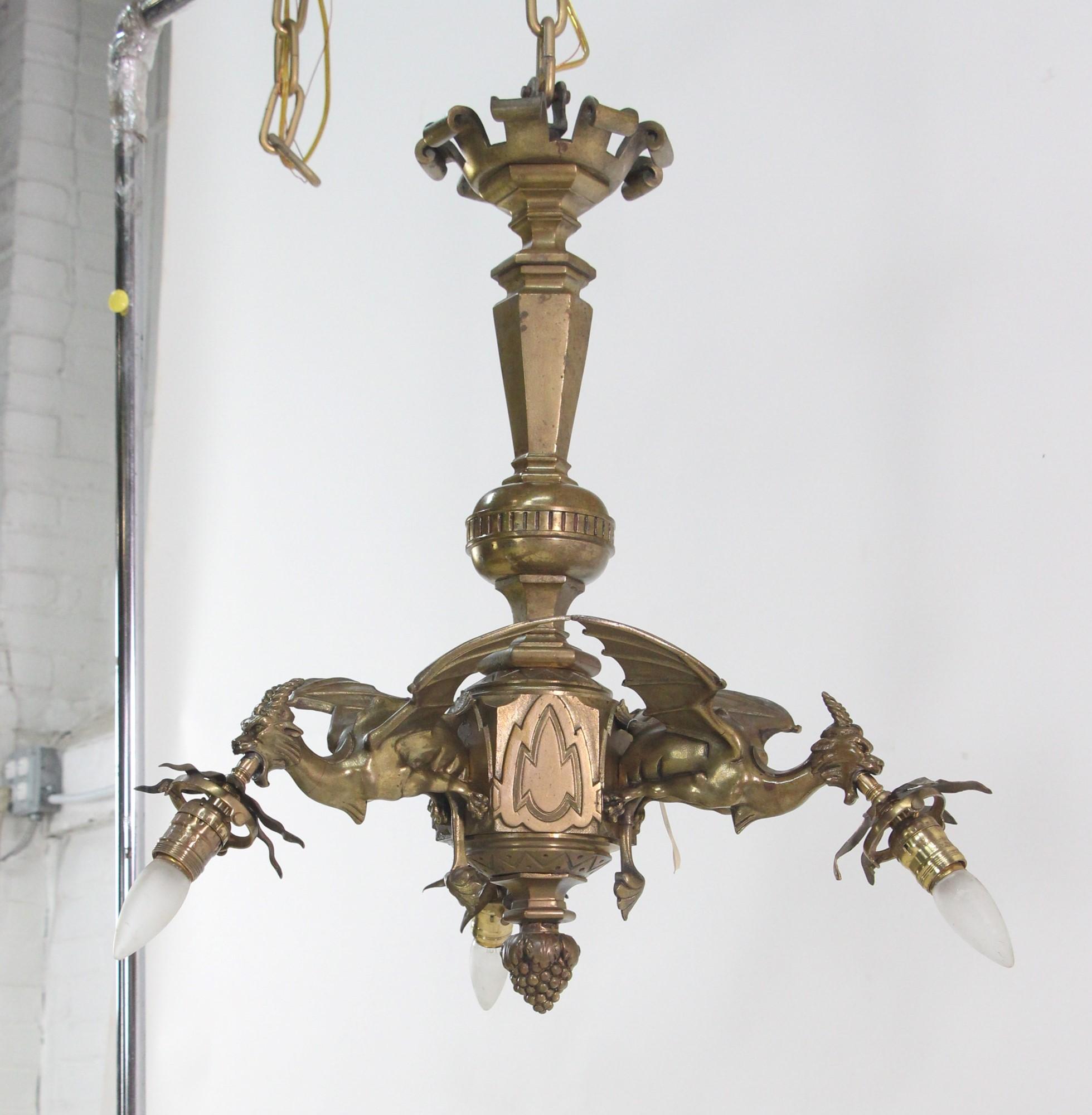 French cast bronze chandelier with three flying griffins each holding a light. This antique gothic light is Circa 1930's. It has been rewired and is ready to ship. This can be seen at our 302 Bowery location in NoHo in Manhattan.

 