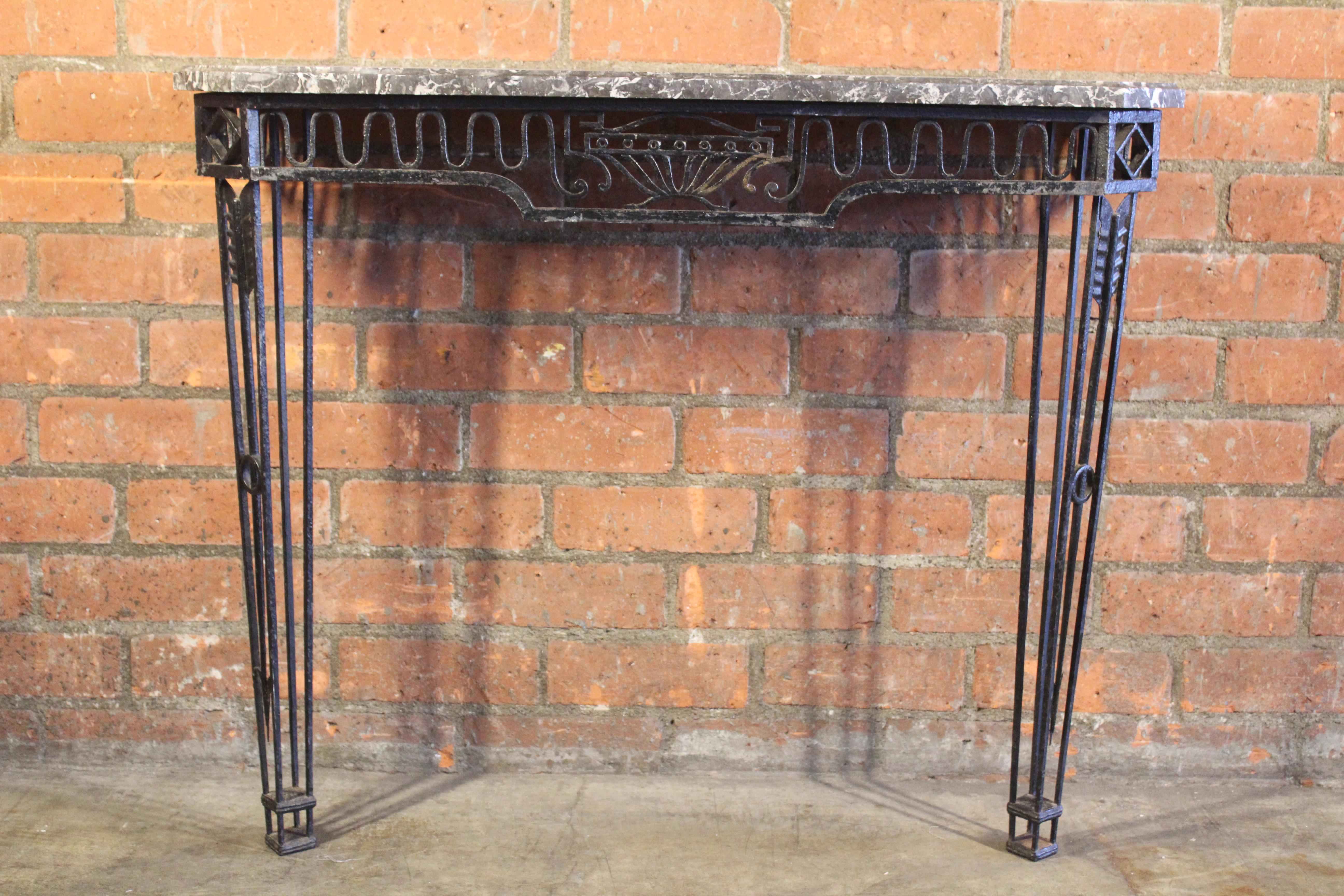 A vintage iron wall mounted console with marble top, France, 1930s. In good condition with patina to the iron.