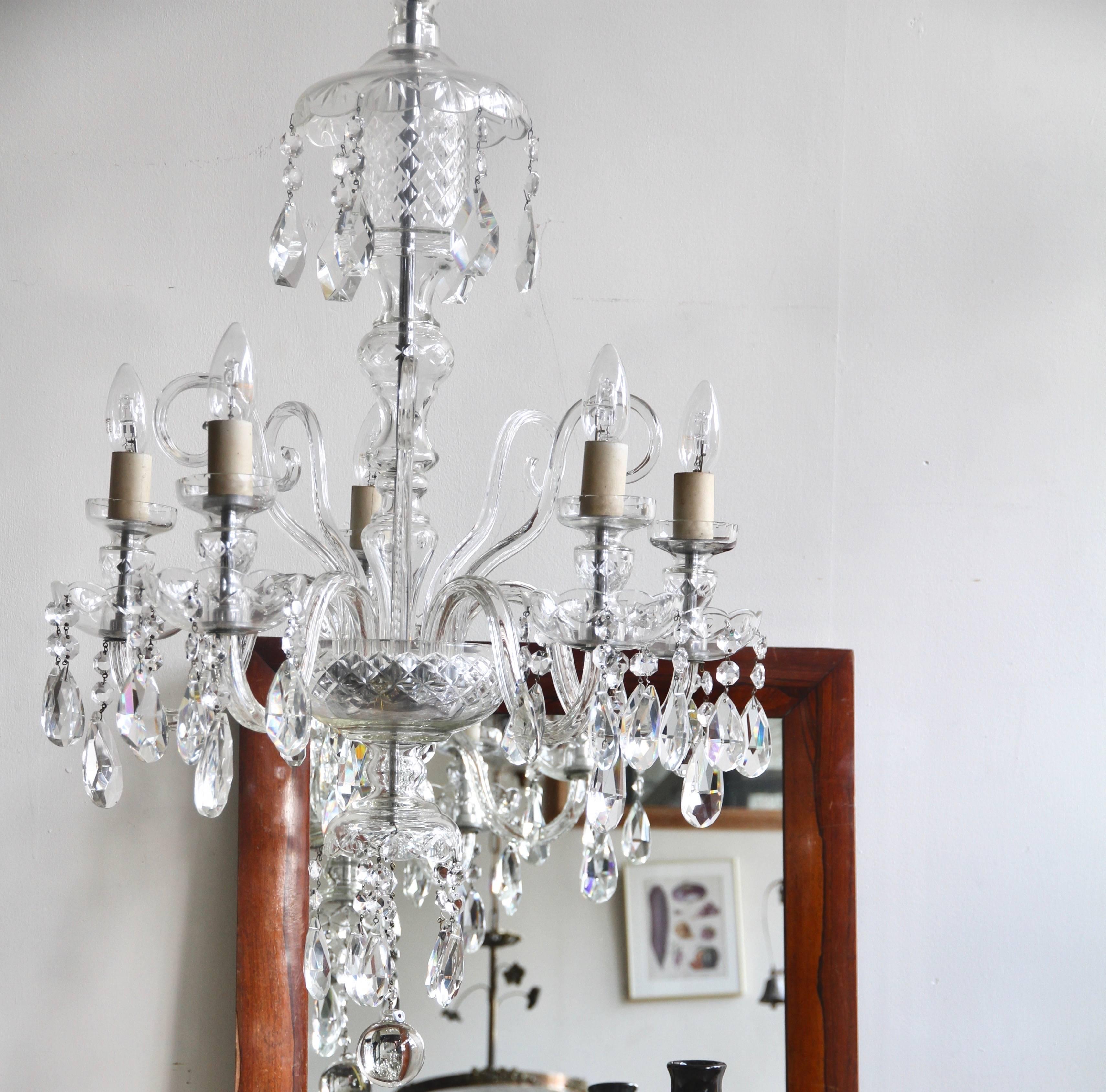 This large Bohemian crystal chandelier originates from 1930s France. Its elegant crystal swan neck arms hold five lamps. Dressed in cut crystal drops with multiple crystal buttons. The chandelier comes supplied with braided flex and chain, ceiling