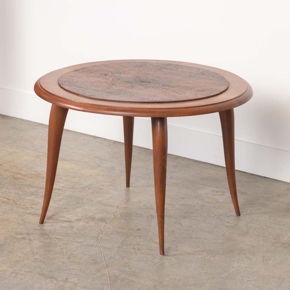 Lovely carved wood side table from France, 1930s. Circular mahogany table with contrasting wood top and striking grain on four curved legs. Newly refreshed finish shows nice natural grain, age, and patina. 