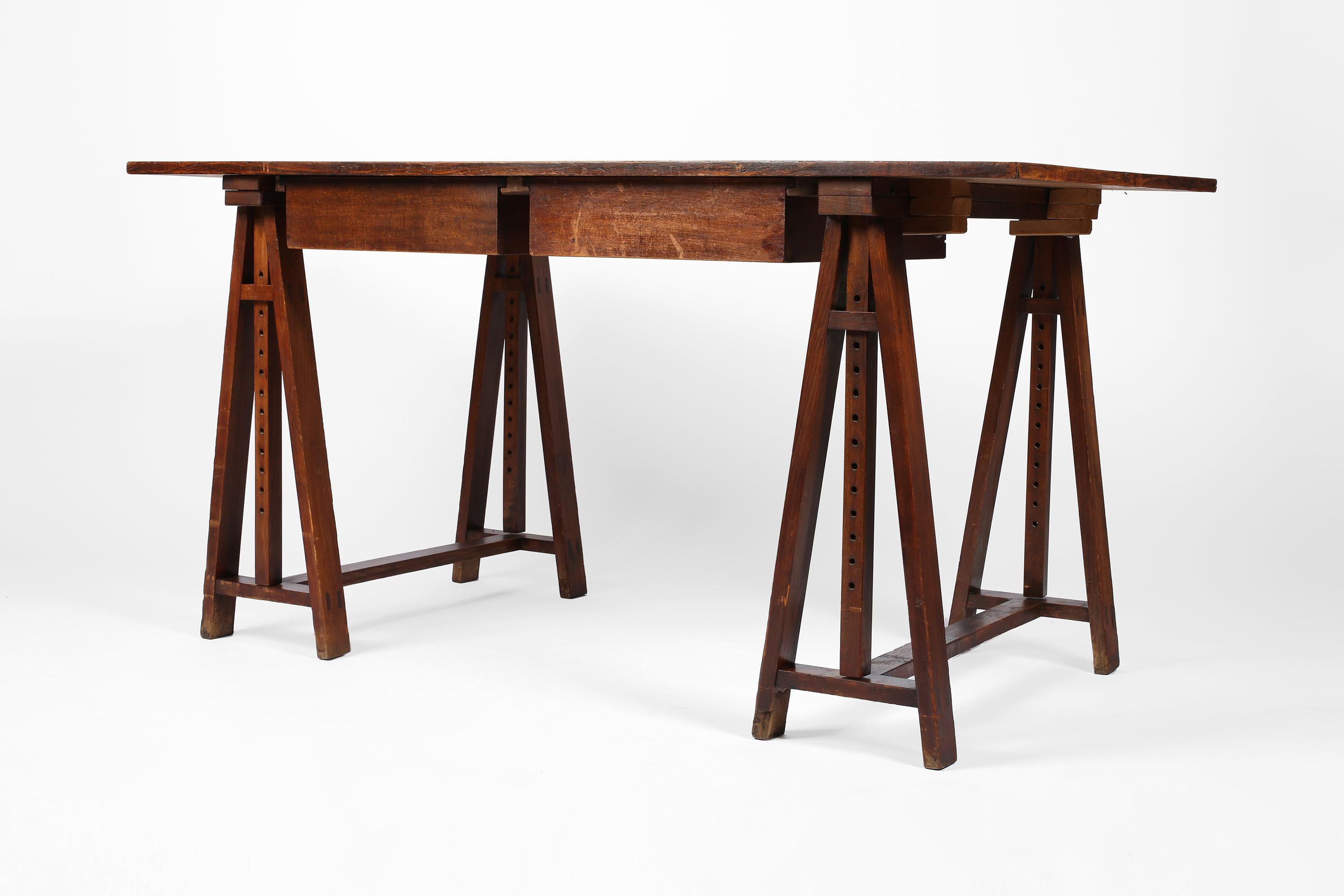 An excellently proportioned early 20th century architect’s desk constructed from solid oak timber. Characterfully patinated from its utilitarian life, the desk featured two drawers and height adjustable trestle legs which ‘lock’ into the underside