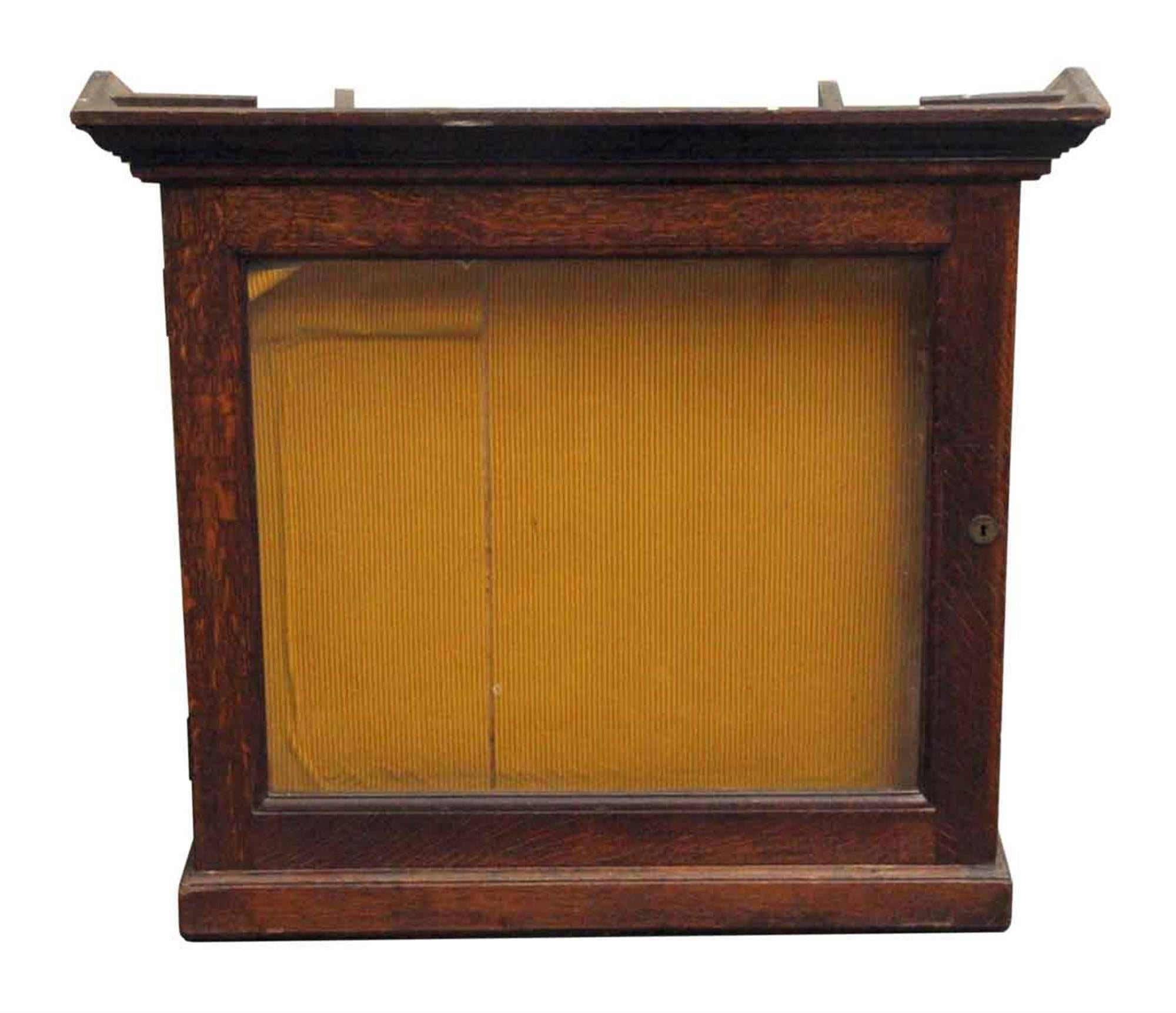 Dark wood tone 1930s French oak display case with key. This can be seen at our 400 Gilligan St location in Scranton, PA.
