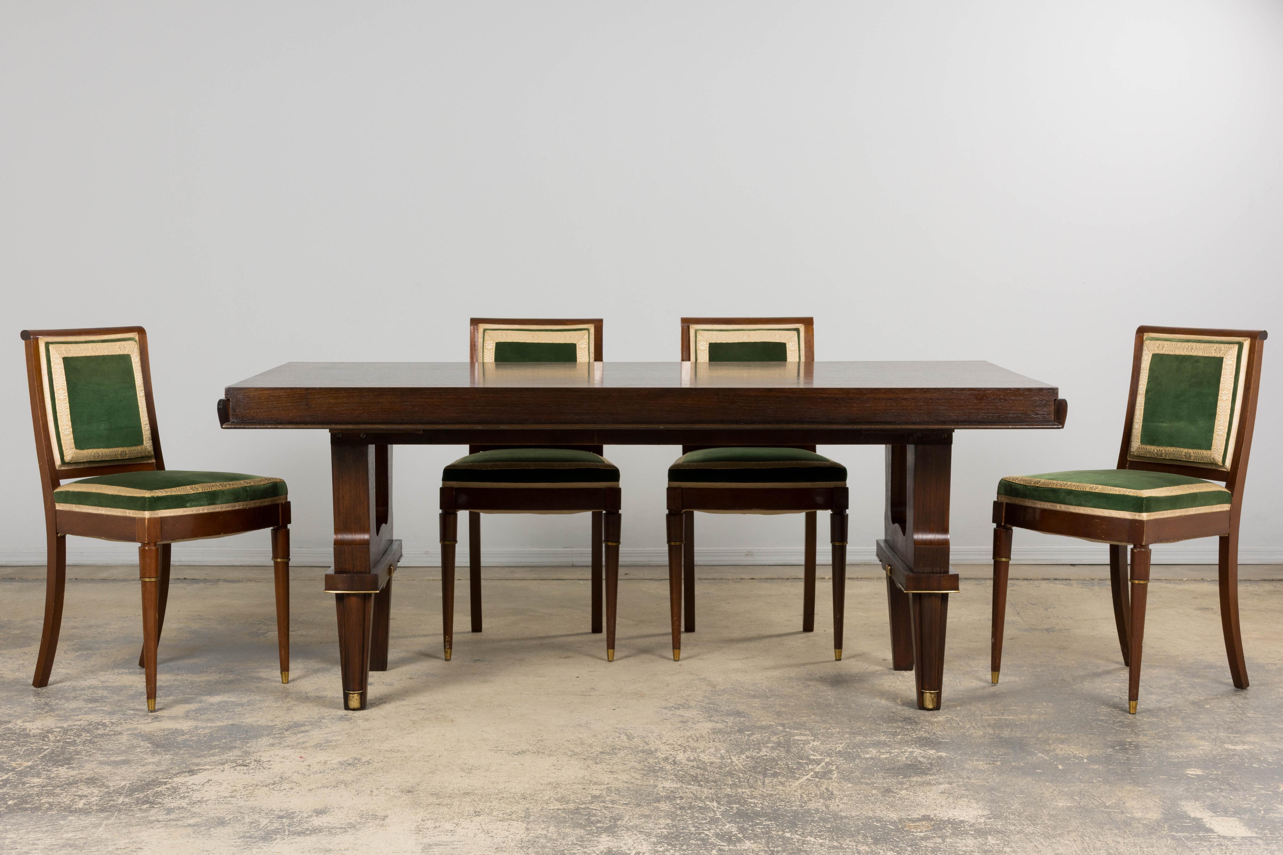A distinguished late 1930s Parisian Art Deco dining table, in the taste of Jules Leleu, sourced in Paris. The rectangular top showcases an exquisite rosewood parquetry veneer laid in a diamond-chevron pattern and framed by a crossbanded mahogany
