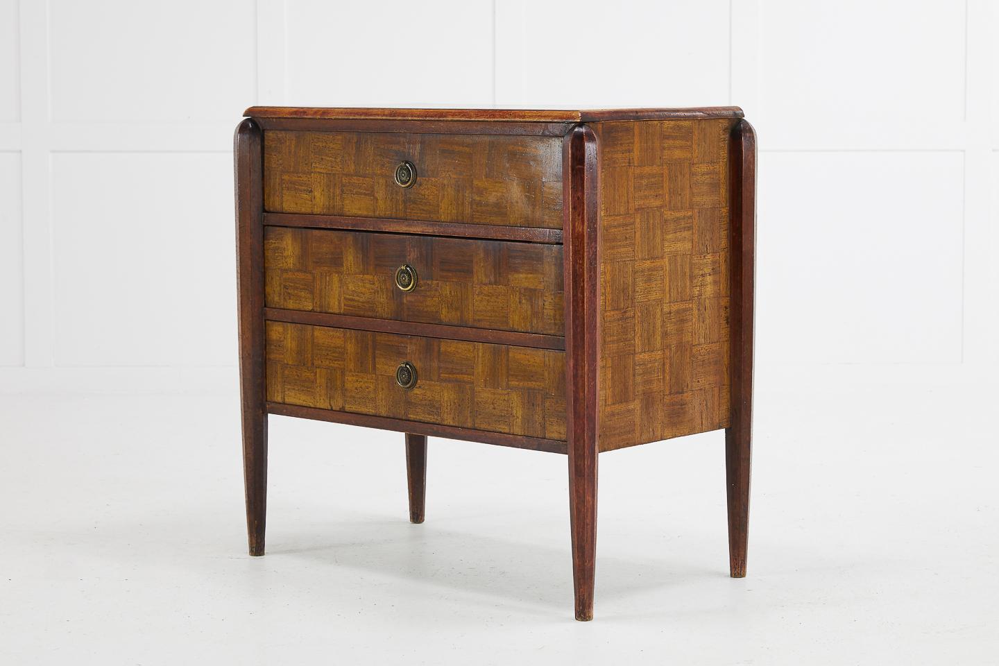 1930s French parquetry commode of small proportion and nice original color.