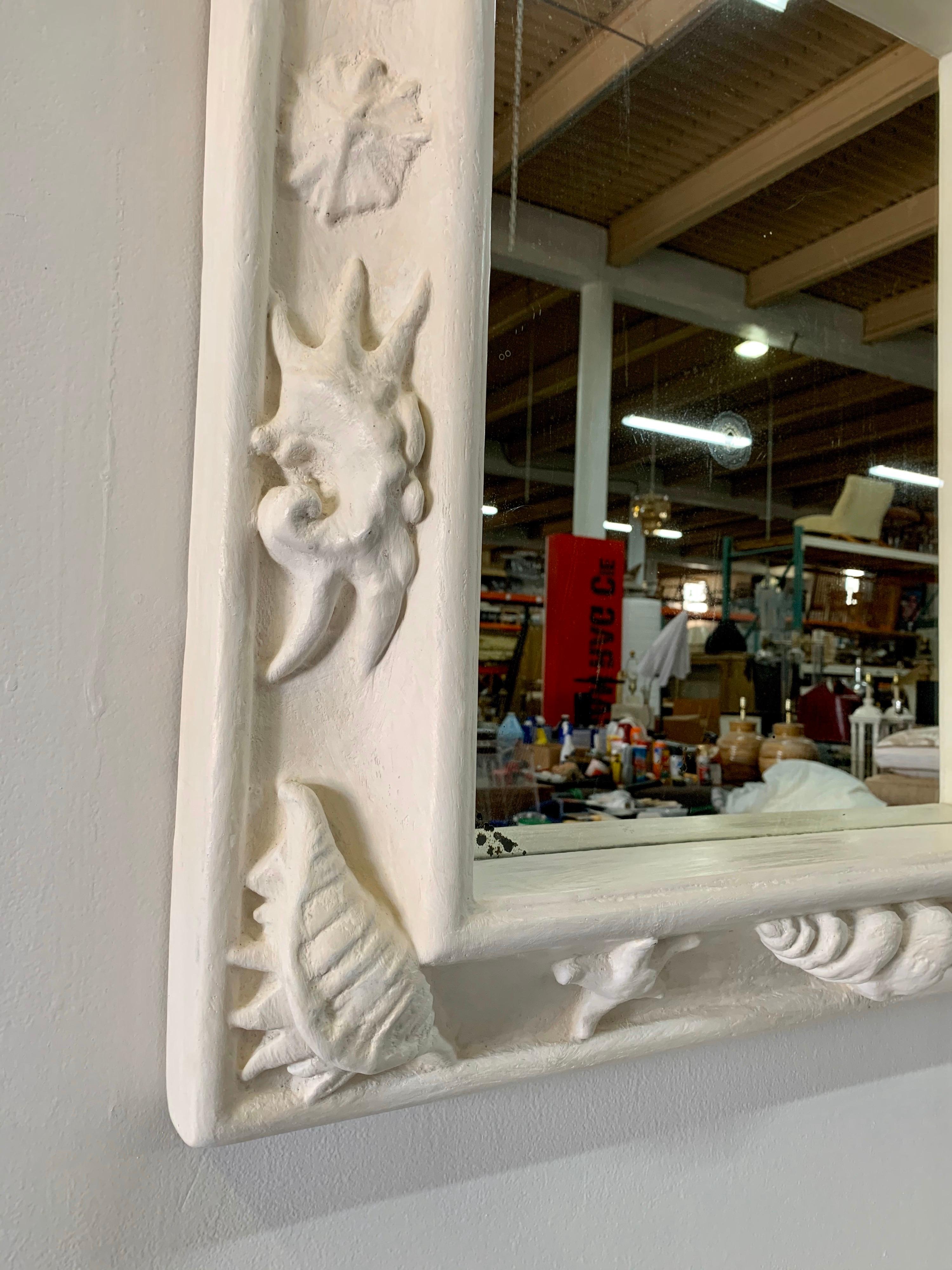 Acquired from the Estate of the late Marques De Sosa in Bal Harbour/Miami, a prominent Swiss-Argentinean collector with galleries in Miami and Monte Carlo. The plaster frame is covered in different shells throughout. Original antique mirror shows
