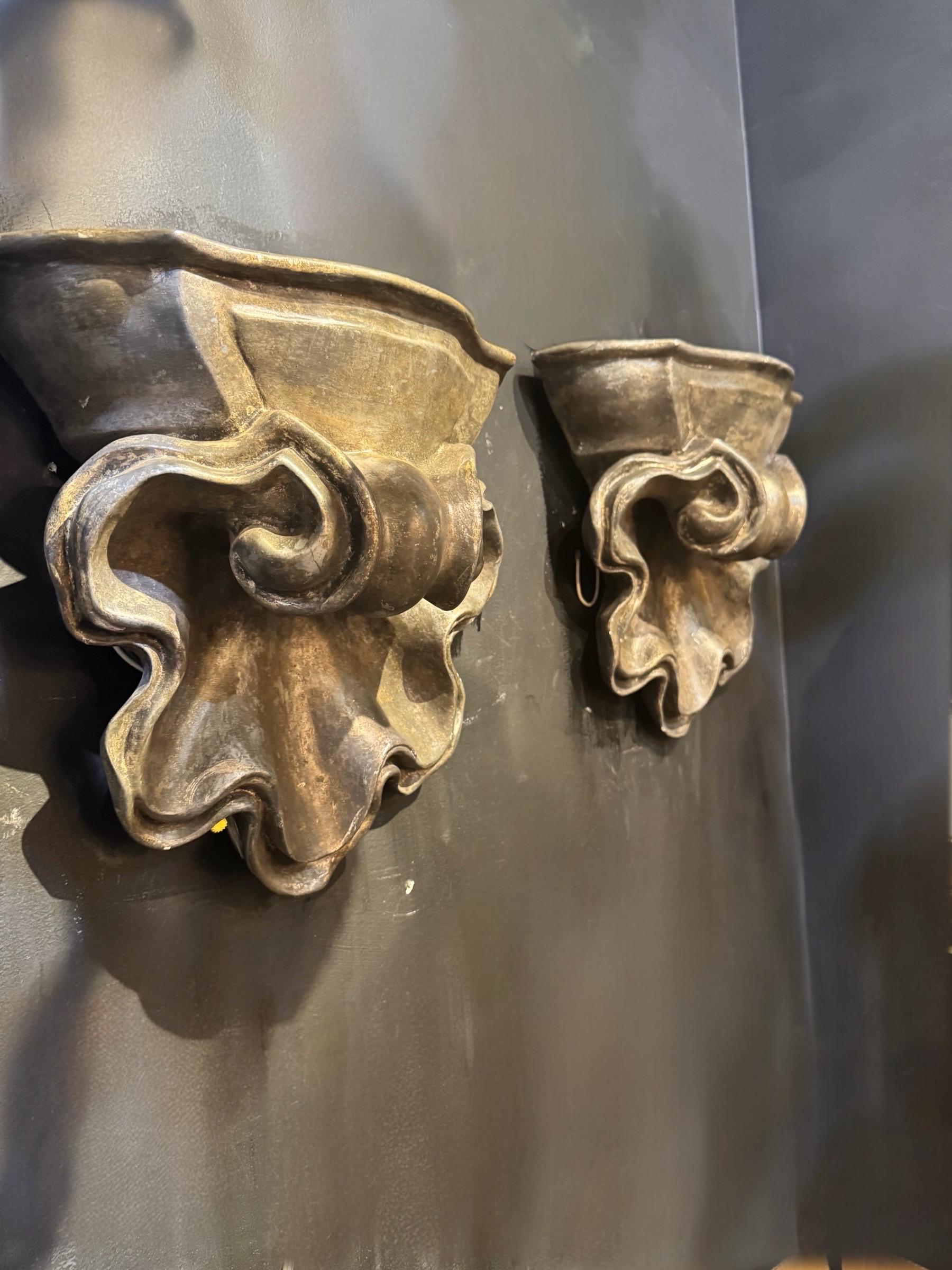 Circa 1930’s French plaster sconces. Has shell shape. With 2 interior lights. Unusual Lights coming from top and bottom part of sconces. Available 3 pairs