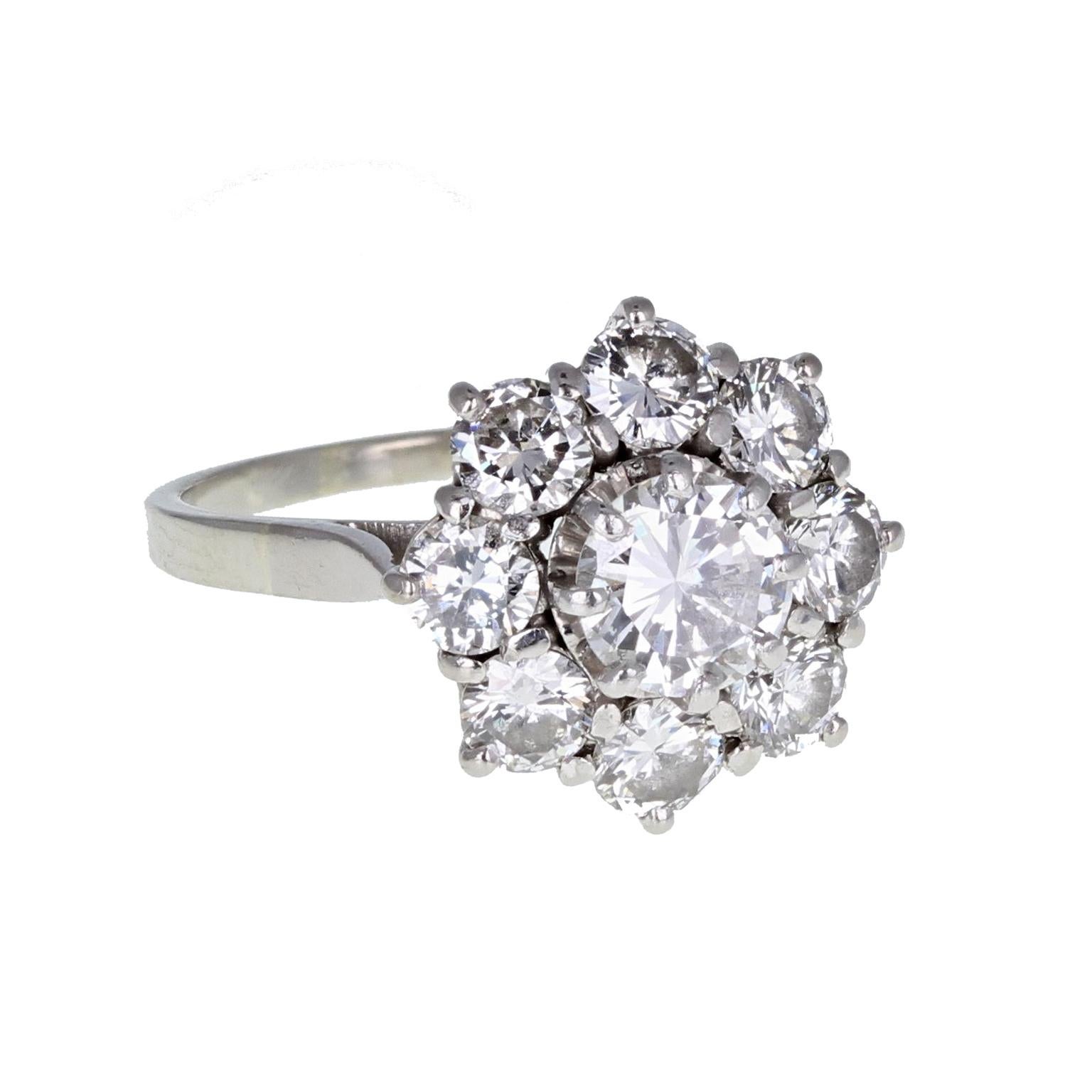 A fine and impressive 1930s diamond daisy cluster ring. french assay marks. The central brilliant-cut diamond of approximately 0.75 of a carat, mounted in platinum claws, surrounded by eight slightly smaller diamonds to form a typical daisy-shaped