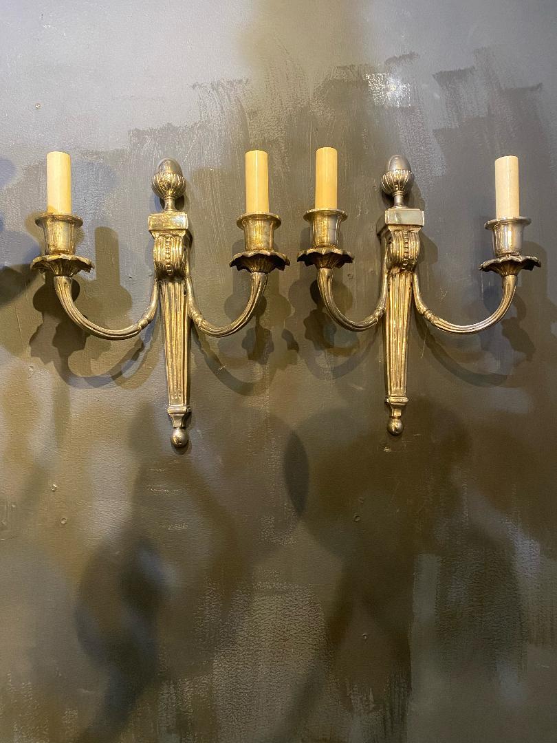 A pair of circa 1930's French silver plated double light sconces.