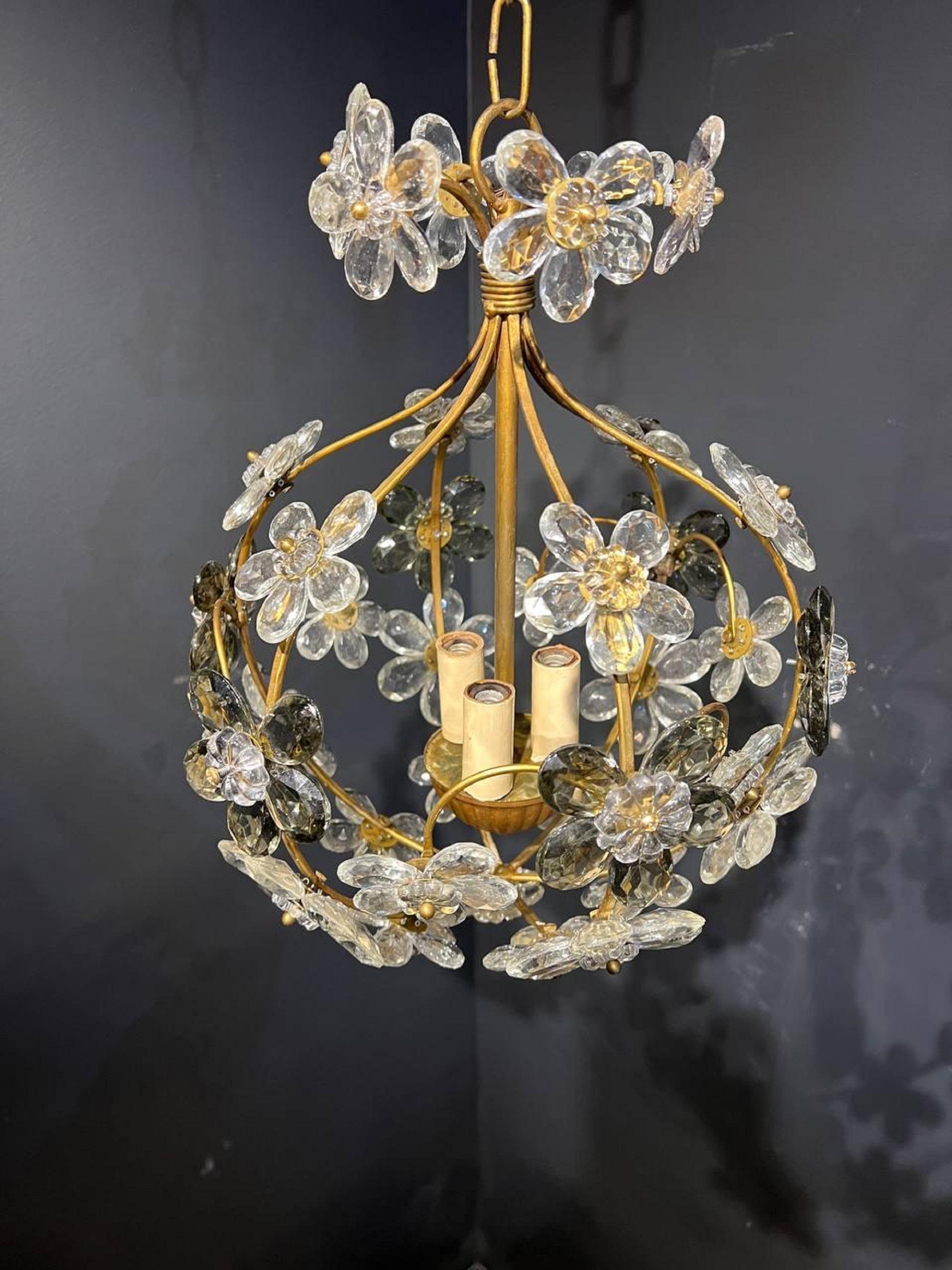 A circa 1930’s French style floral crystal chandelier with interior lights. Two colors of crystals white and black. Up to 120V (US Standard): Hardwired. In very good vintage condition. 

Dealer: G302YP.

